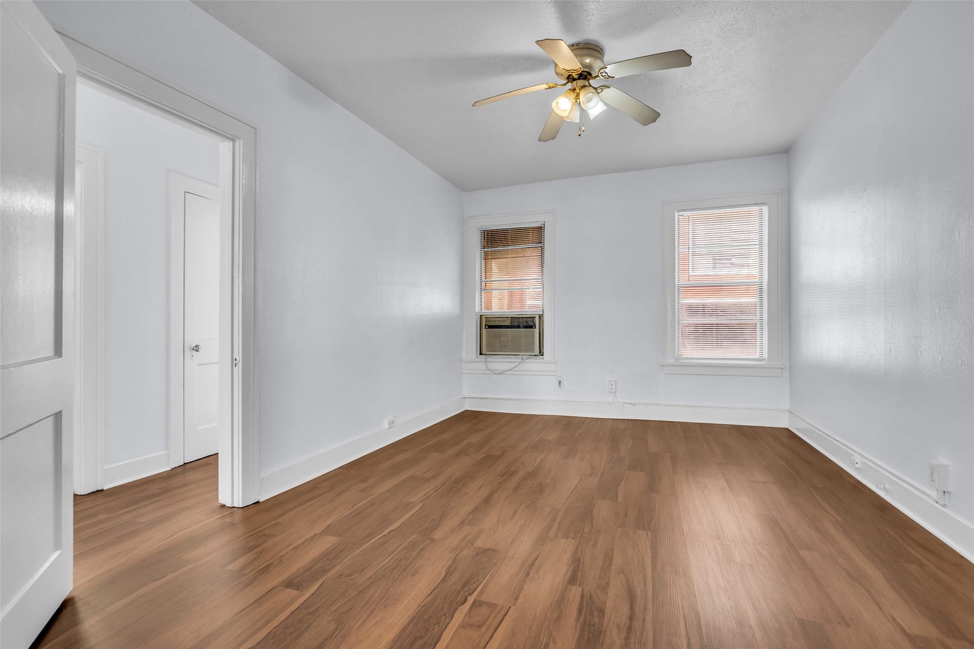 The dining area features warm wood flooring and a ceiling fan that helps maintain comfortable airflow. Its inviting layout provides a practical space for everyday meals and gatherings.