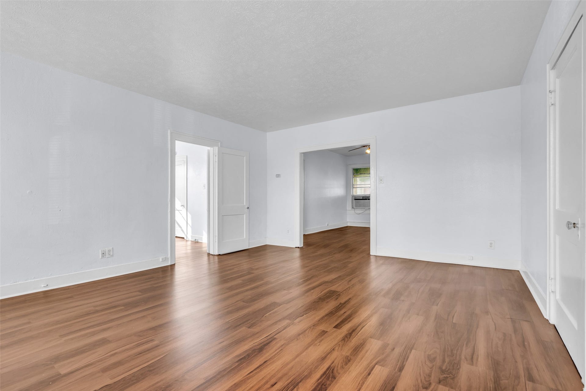 The spacious dining area provides plenty of room for meals and gatherings, with doors connecting to other areas of the home for easy access and flow between spaces.