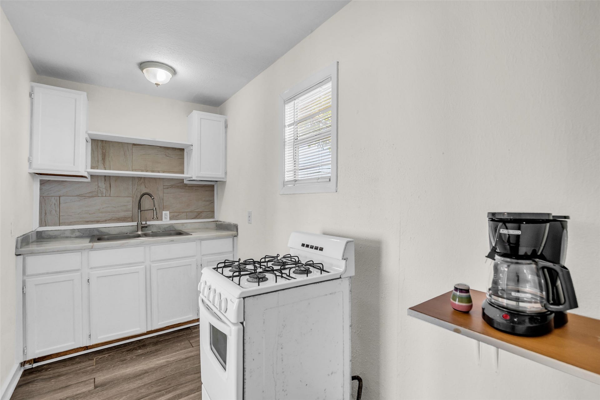 The second-floor duplex kitchen features a compact, practical layout with everything conveniently arranged for everyday meal preparation and use.