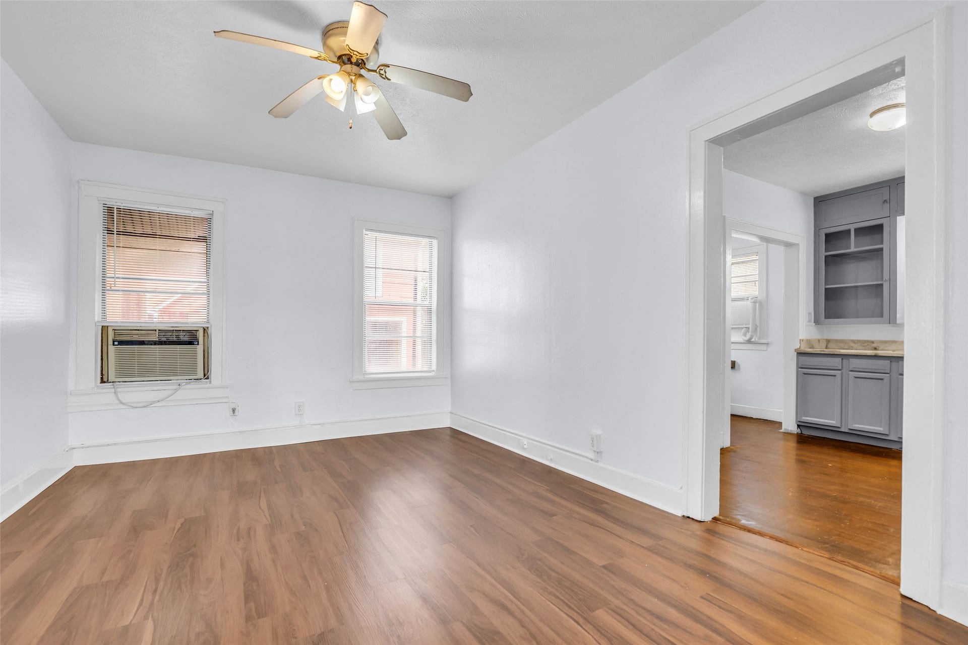 An additional view of the dining area highlights convenient connection to the kitchen through a nearby door, creating an easy flow between the two spaces.