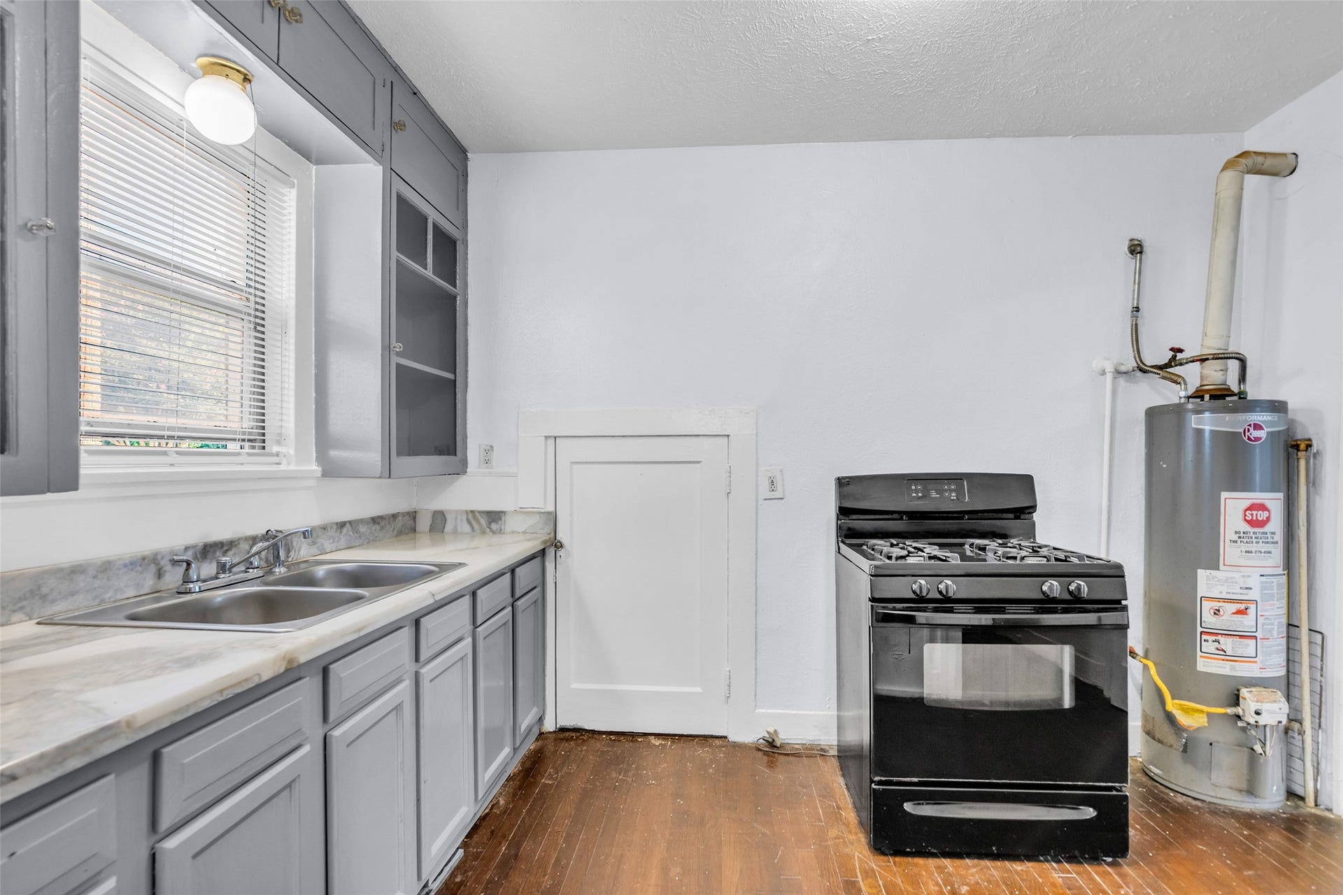 The kitchen features a double sink, ample cabinetry for storage, and a convenient pantry.