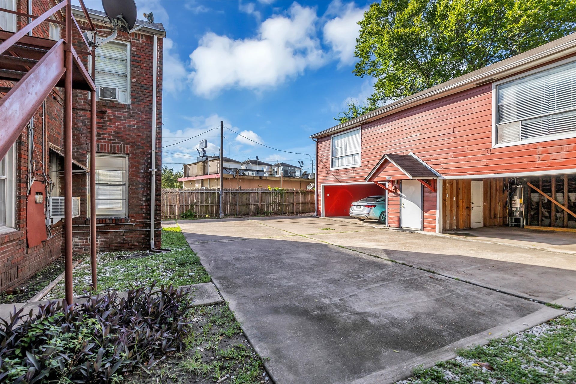 The property includes a garage with a separate residential unit located above it, providing a practical combination of parking and additional living space.
