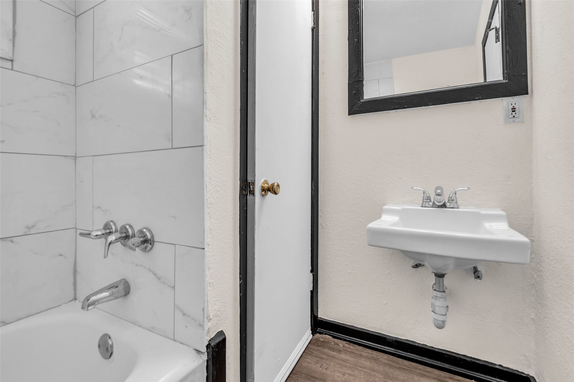 The second-floor bathroom features a convenient tub and shower combination, providing a practical and comfortable space for everyday use.