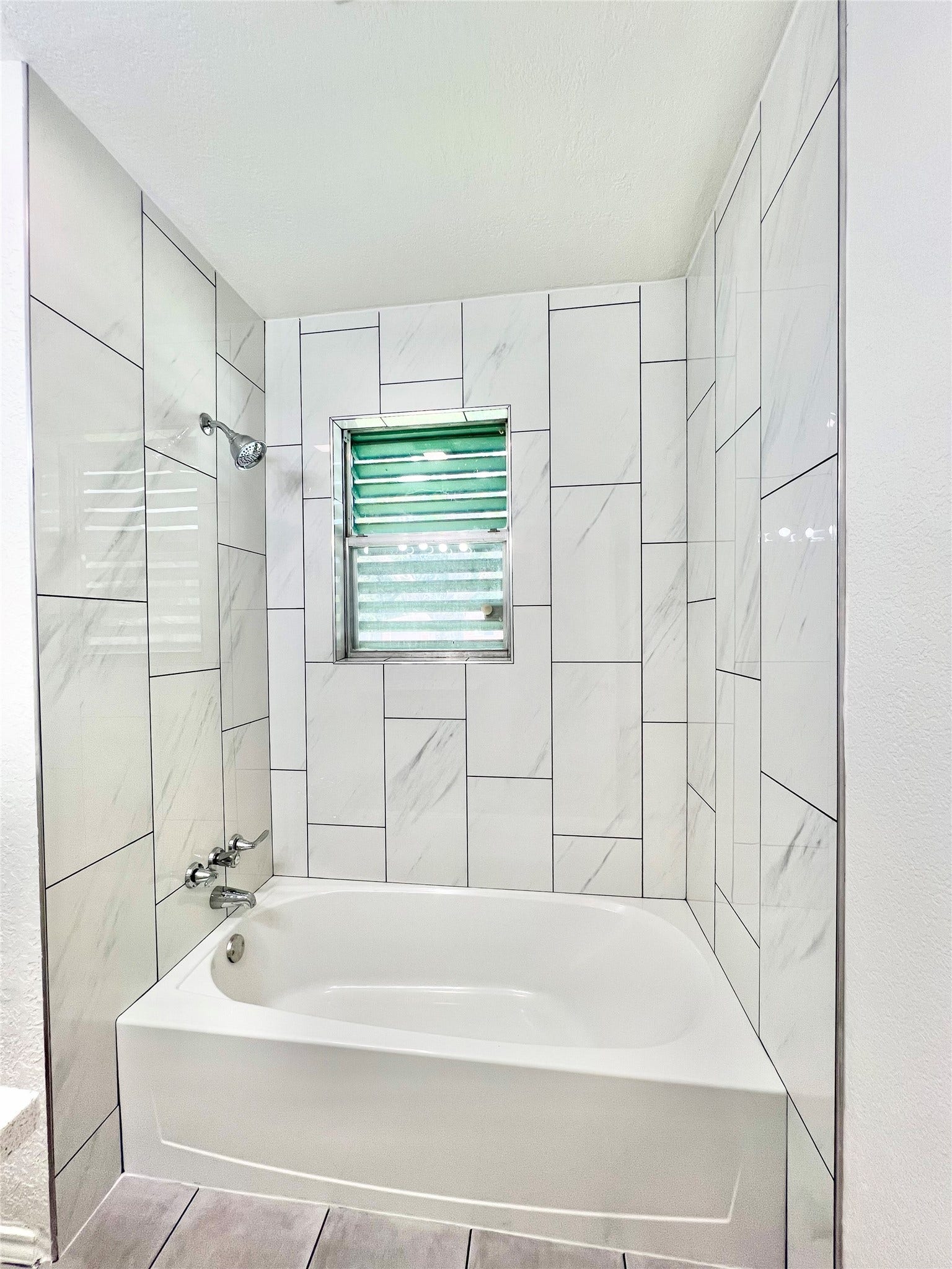 11815 15th Street, Santa Fe, TX 77510 Floor to ceiling tile in the newly remodeled Bathroom