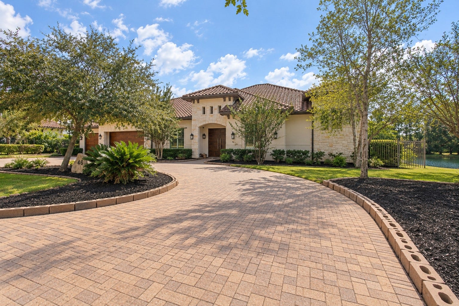 46 Lamerie Way, The Woodlands, TX 77382 Impressive horseshoe-shaped paver driveway creates a grand entrance, surrounded by beautifully landscaped grounds and offering an elegant welcome to this luxury estate.