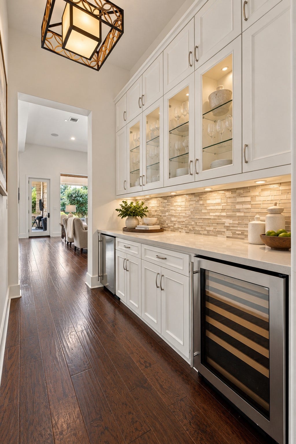 46 Lamerie Way, The Woodlands, TX 77382 Elegant butlers pantry and beverage center featuring custom cabinetry, glass-front displays, generous counter space, and built-in beverage refrigeration.