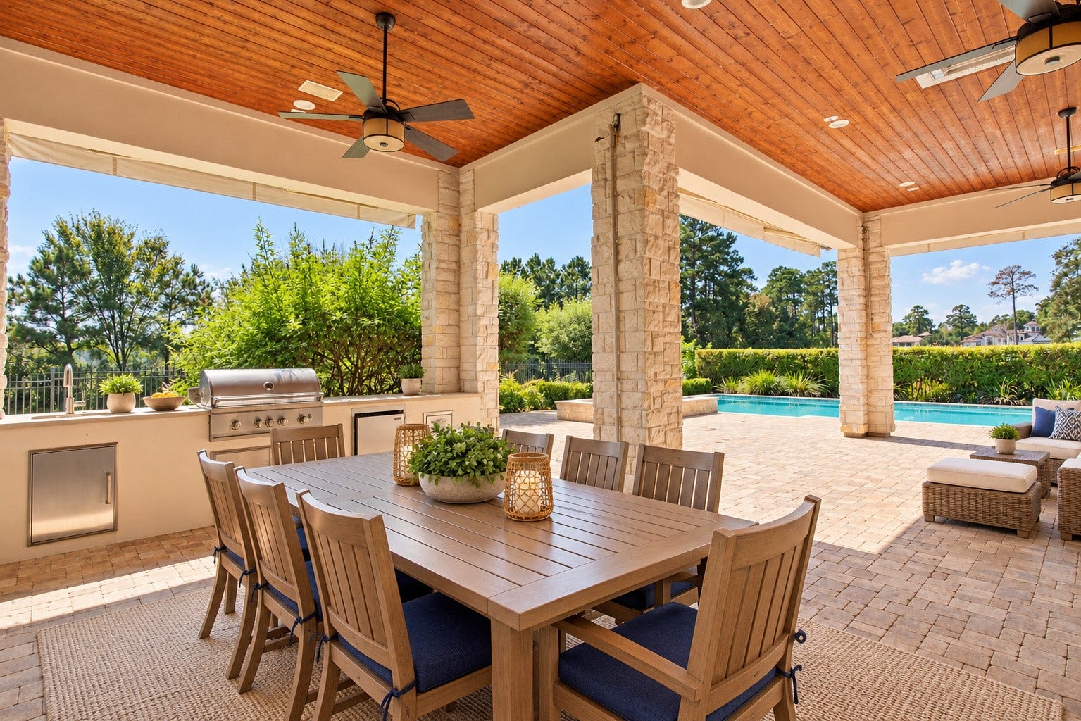 46 Lamerie Way, The Woodlands, TX 77382 Impressive outdoor dining area featuring a rich wood-paneled ceiling, beautiful stone columns, and a fully equipped summer kitchen overlooking the pool.