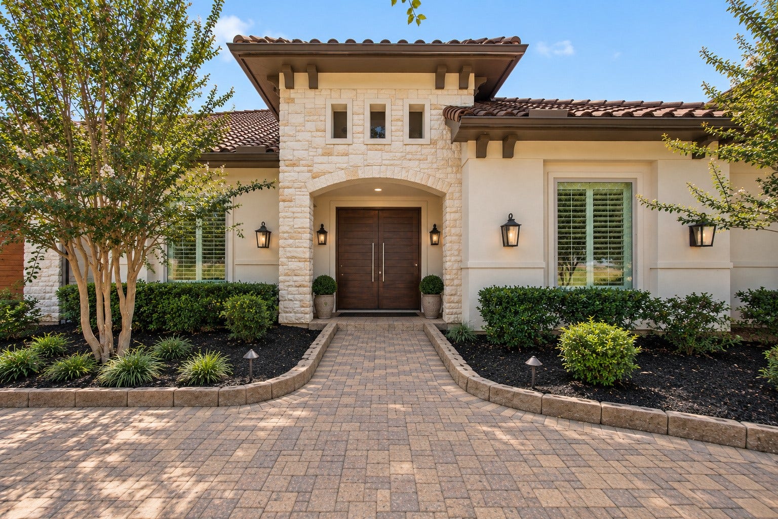46 Lamerie Way, The Woodlands, TX 77382 Grand entrance featuring striking stone architecture, elegant double doors, and beautifully manicured landscaping, creating an impressive welcome to this luxury estate.