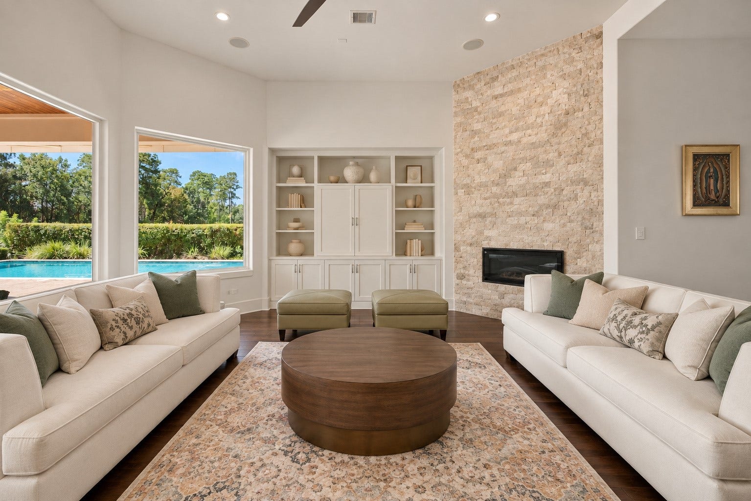46 Lamerie Way, The Woodlands, TX 77382 Picturesque living room featuring a stunning stone fireplace, elegant finishes, and expansive windows overlooking the resort-style pool and covered patio.