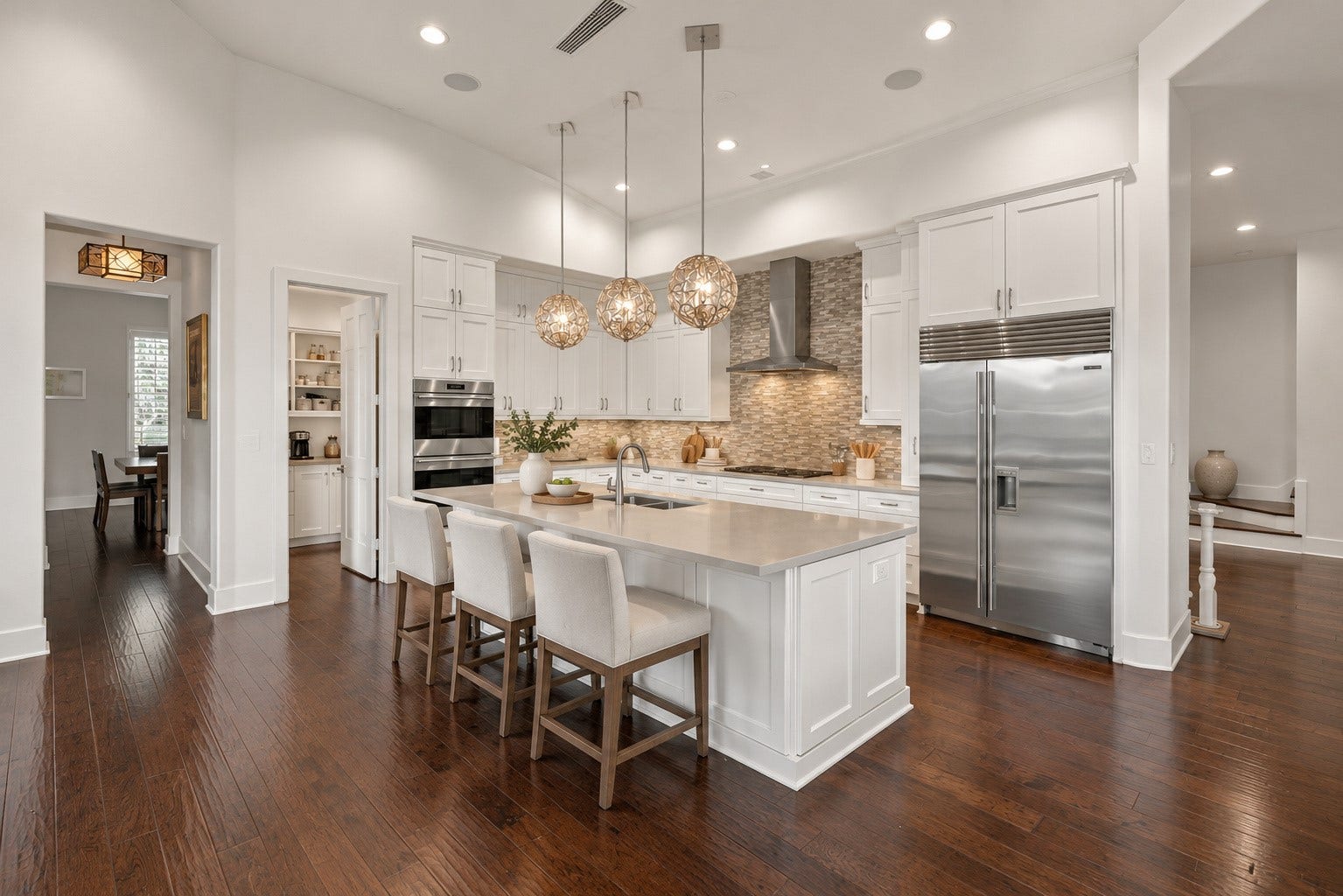 46 Lamerie Way, The Woodlands, TX 77382 Gourmet kitchen featuring a spacious center island, elegant pendant lighting, custom cabinetry, and premium stainless steel appliances.