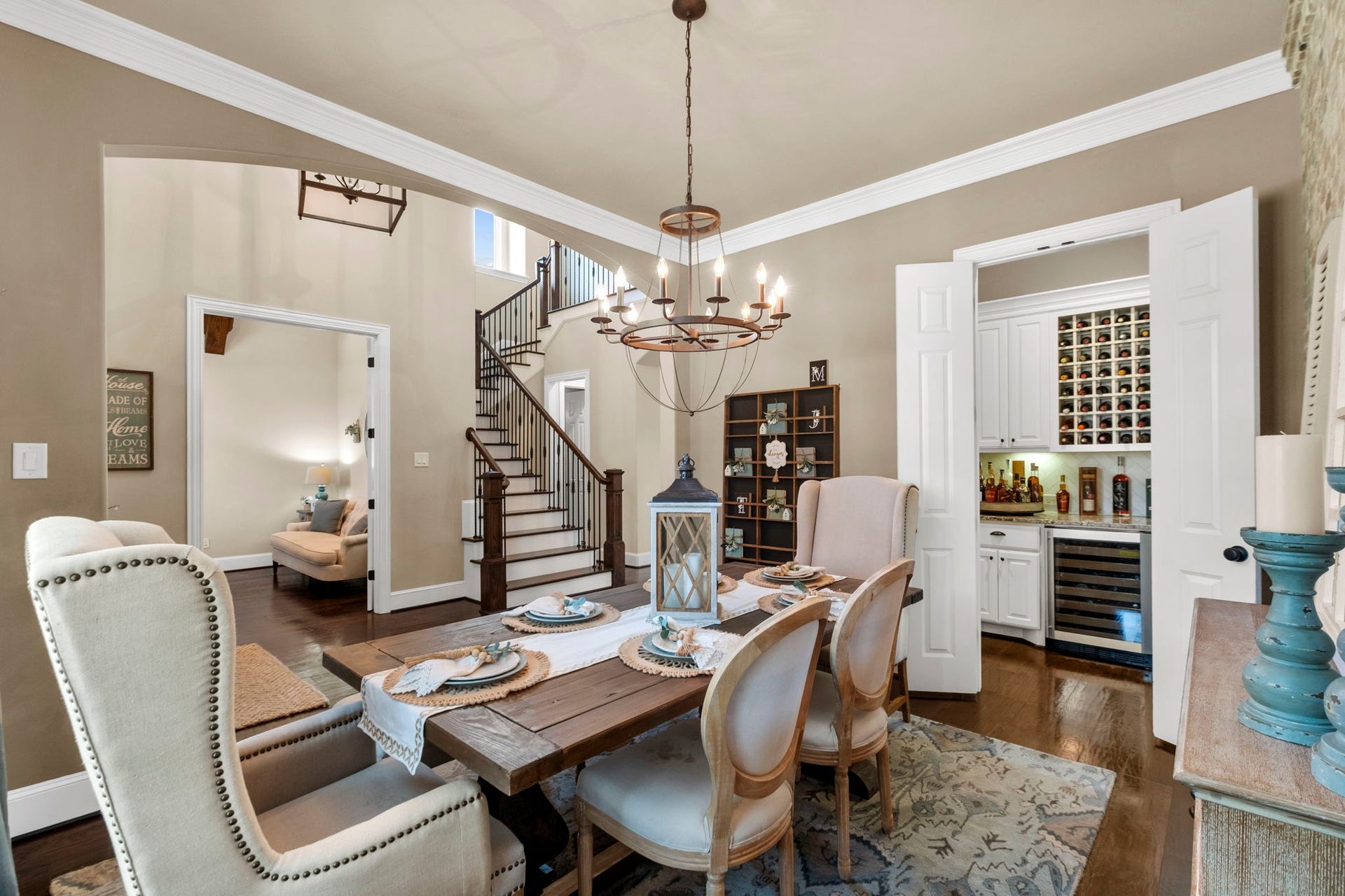 34 Stefano Way, Missouri City, TX 77459 View from the formal dining room showing its open flow into the foyer, direct access to the dry bar area through double folding doors, and high ceiling with crown molding details.