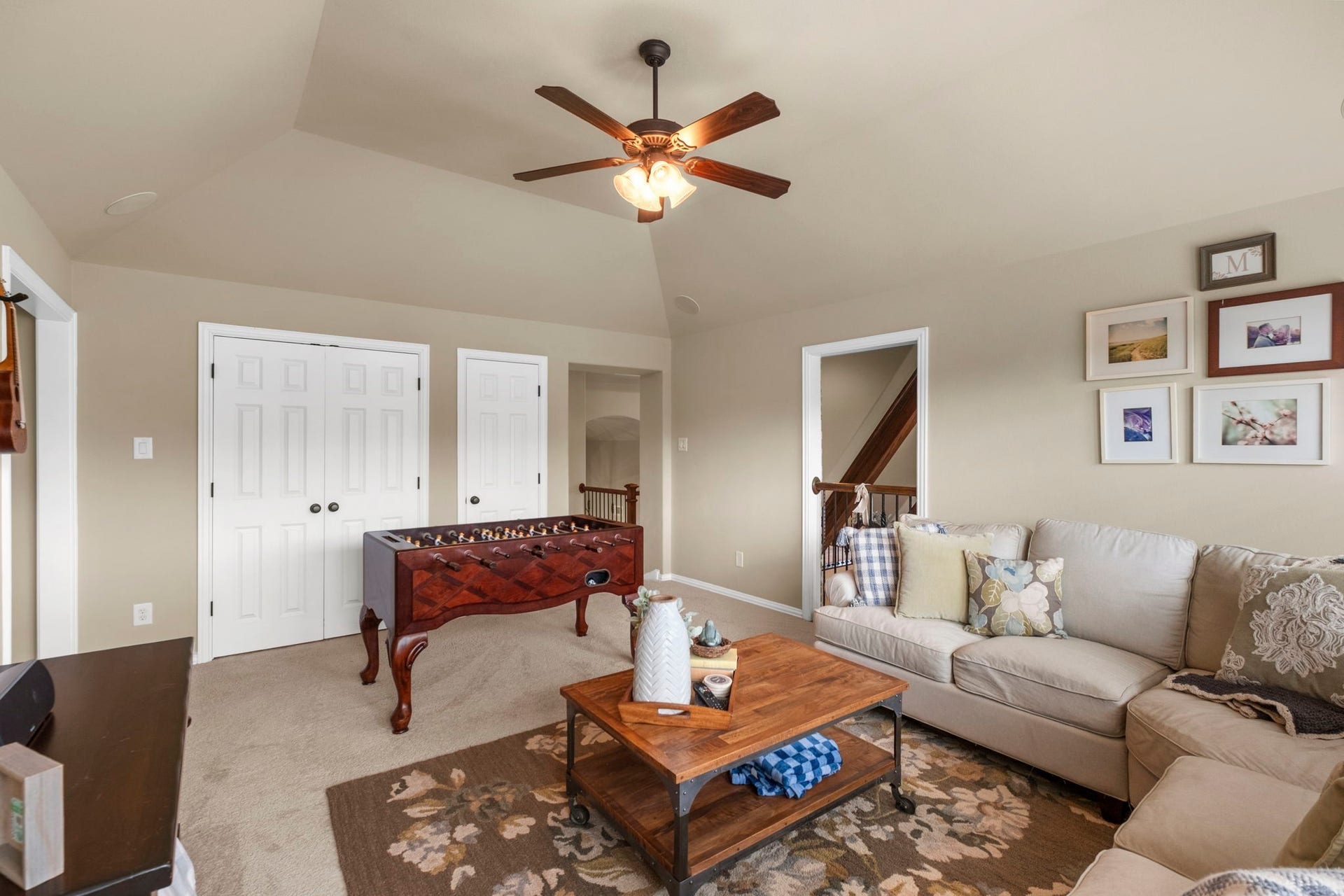34 Stefano Way, Missouri City, TX 77459 Alternate view of the spacious second-floor game room highlighting vaulted ceilings, multi-panel closet doors, direct access to the staircase landing area, and open flow for versatile layout options.