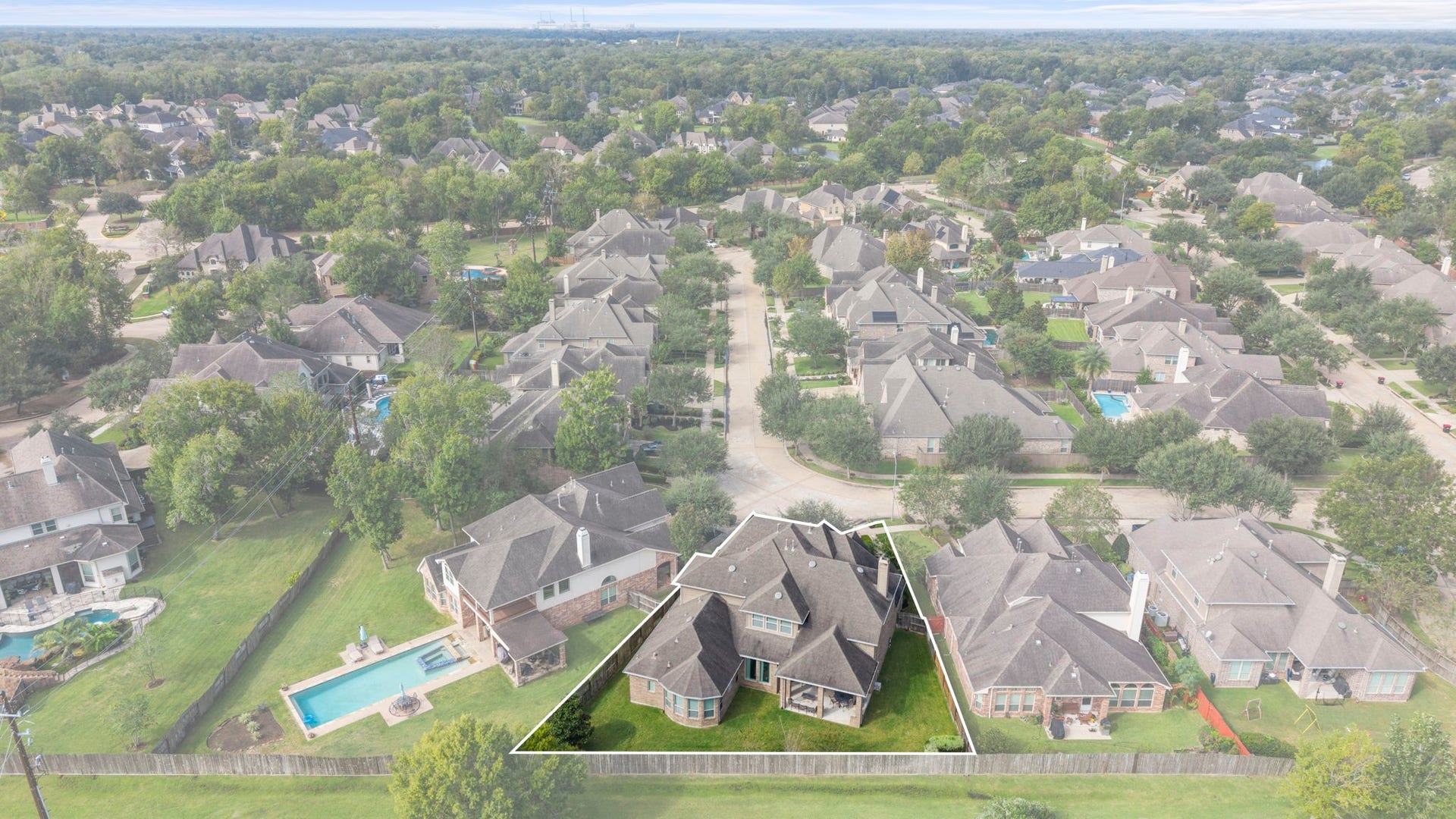 34 Stefano Way, Missouri City, TX 77459 Wide aerial photograph showing the surrounding residential community, tree-lined neighborhood streets, mature canopy, and proximity to neighboring green spaces.