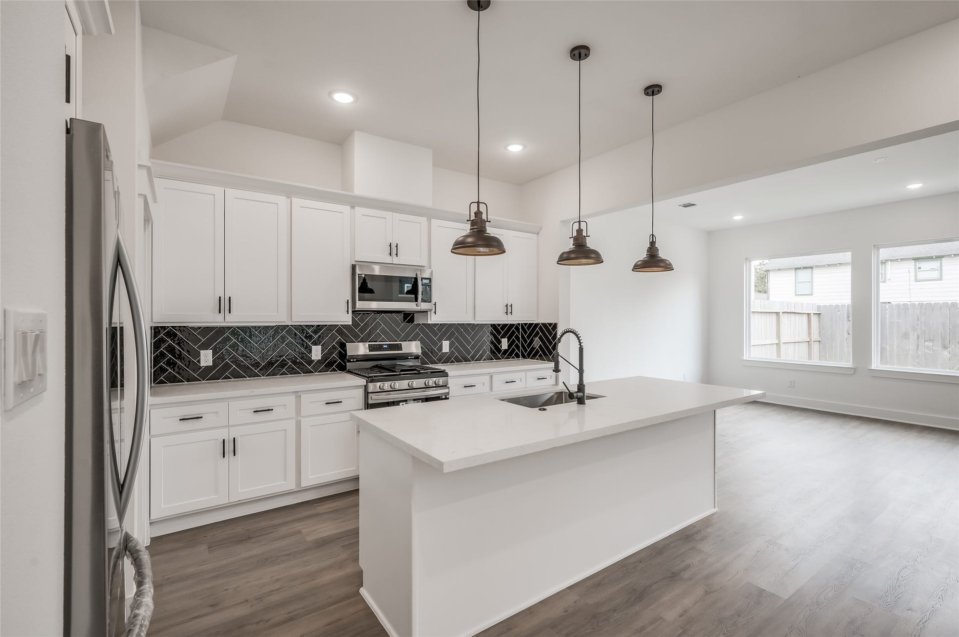 4605 Terry Street, Houston, TX 77009 The kitchen shines with a generous island and warm pendant lighting, the kind of space that pulls everyone in around the counter
