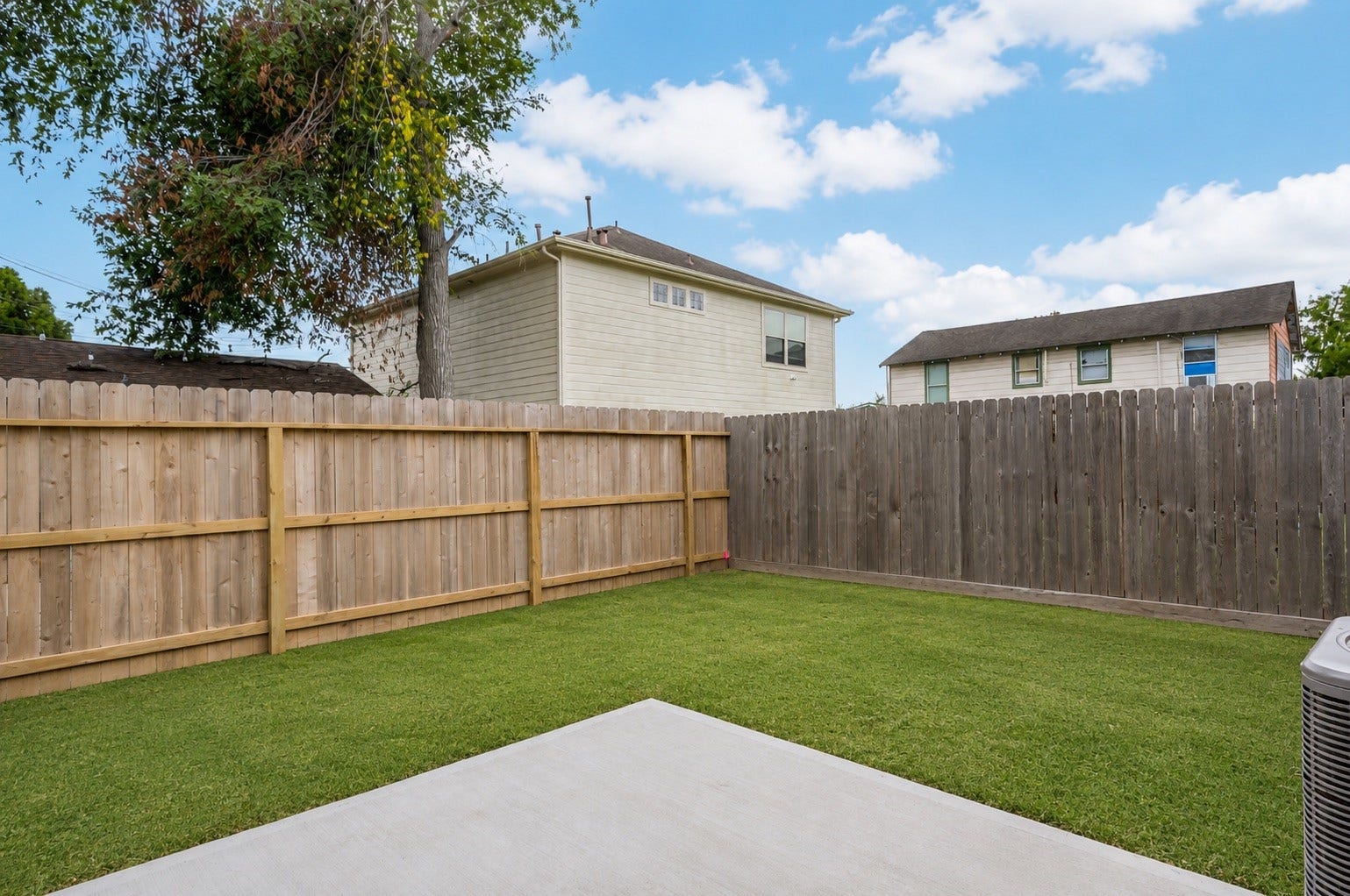 4605 Terry Street, Houston, TX 77009 The fenced backyard offers a private patch of green, ready for pets, play, or relaxing evenings outside