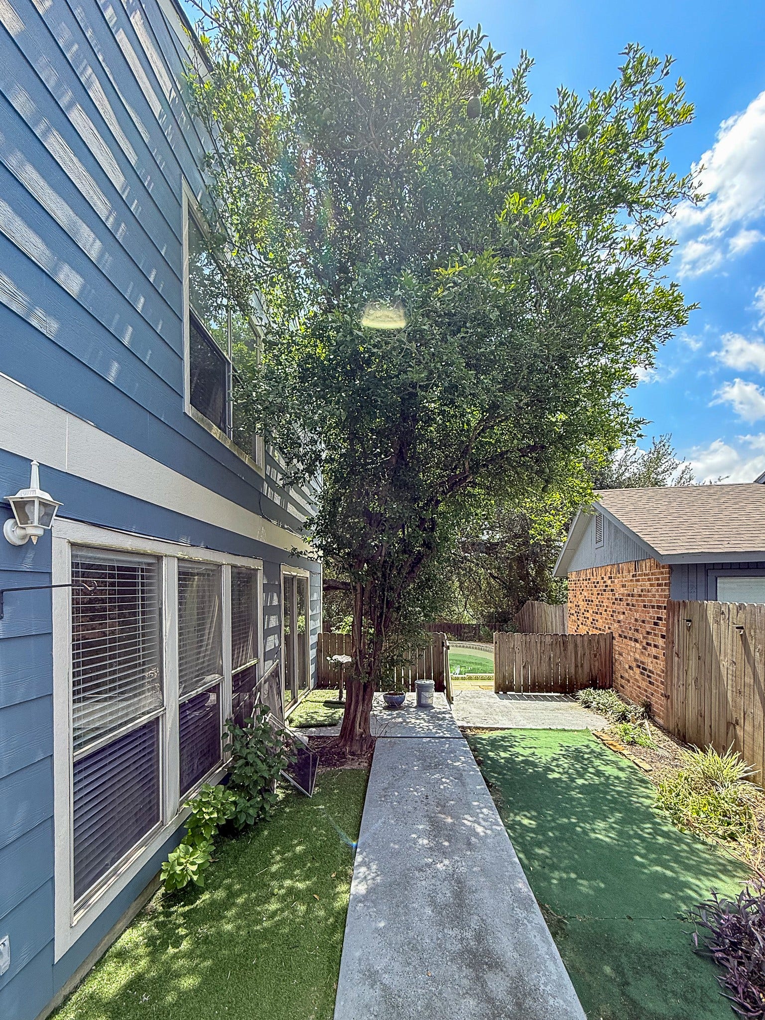 Charming pathway from the front or the side sliding doors lead to your backyard oasis.