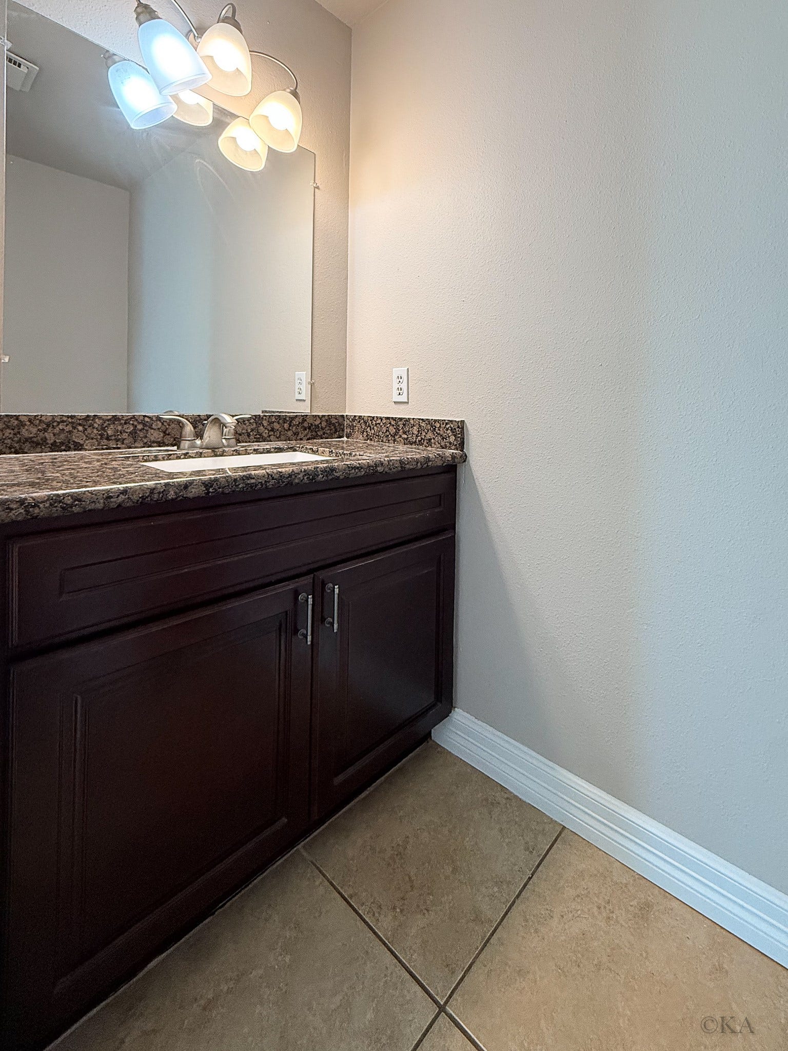 Half bathroom is located on the first floor off the kitchen