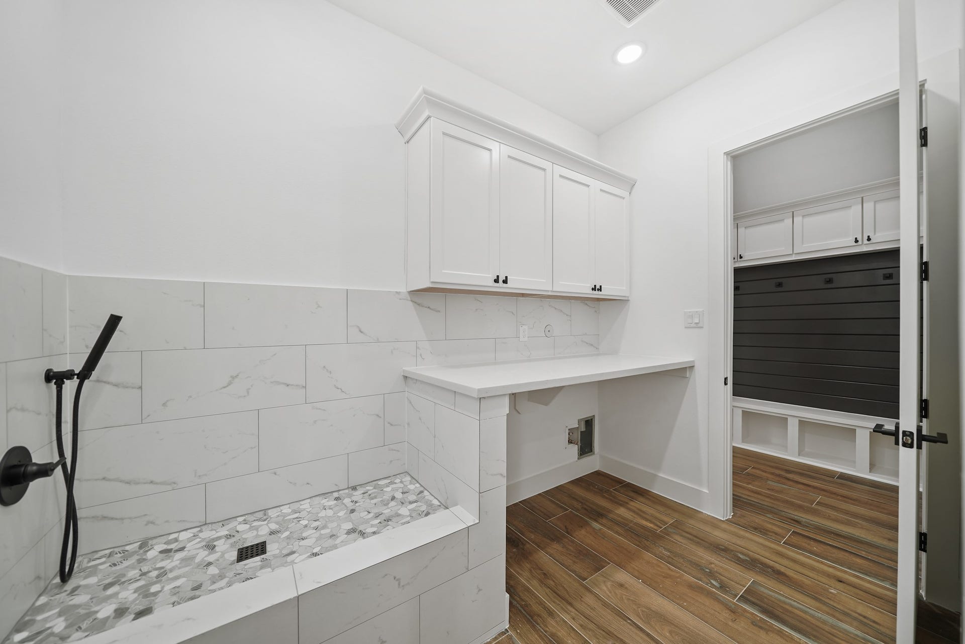 Efficiency meets luxury in the centrally located laundry room. Enjoy the convenience of a luxury pet shower and direct access to the primary closet for added functionality.