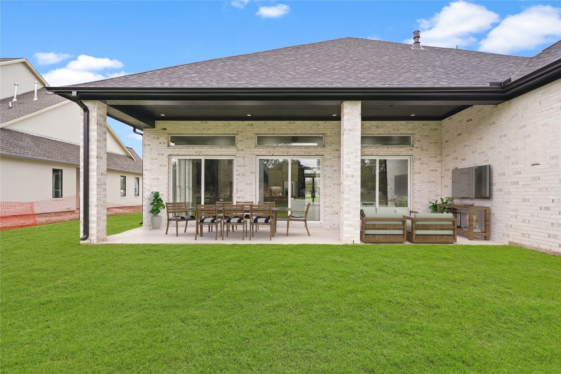 Embrace the outdoors in the expansive back patio, featuring soaring high ceilings that ensure abundant natural light floods the space. Carefully designed to avoid compromising the brightness of the house, this outdoor retreat offers a seamless blend of comfort and openness. Whether entertaining guests or enjoying a quiet moment, the abundant patio invites you to savor the beauty of the outdoors without sacrificing the luminosity of the home's interior. Virtually staged. Perimeter fence has been installed.