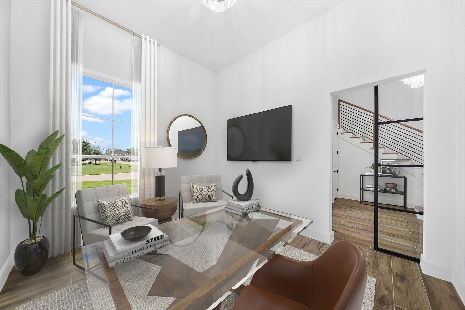 Discover a tranquil retreat in the study, strategically placed in the front of the house to capture abundant natural light. The high ceilings enhance the spacious feel, while the steel barn door adds a touch of contemporary elegance to this inspiring workspace. Virtually staged.