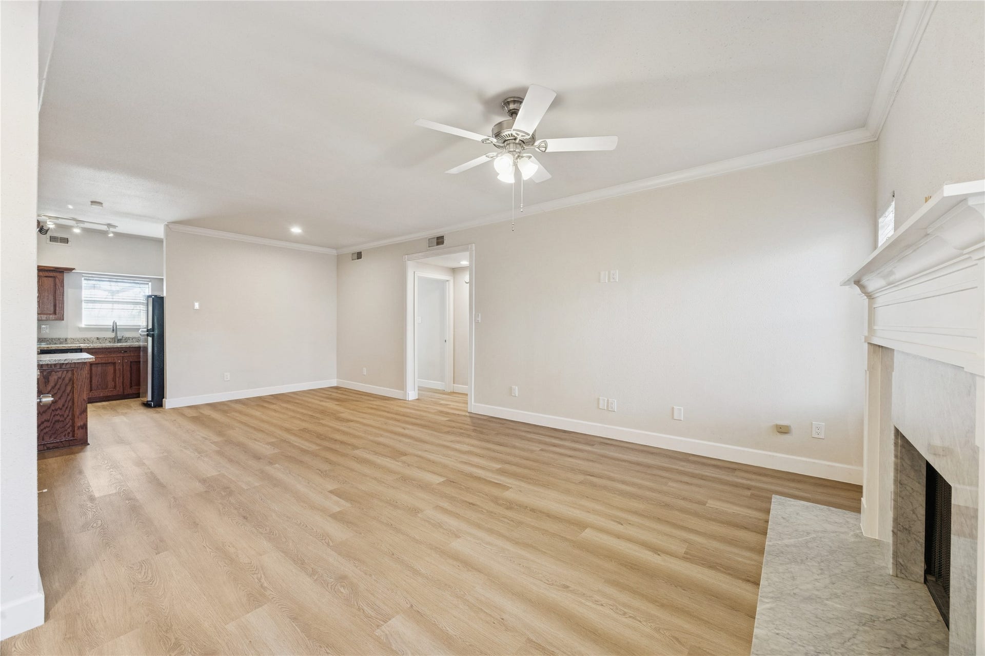 4041 Law Street, #512, Houston, TX 77005 A view of living room and kitchen / dining area from the beautiful fire place.