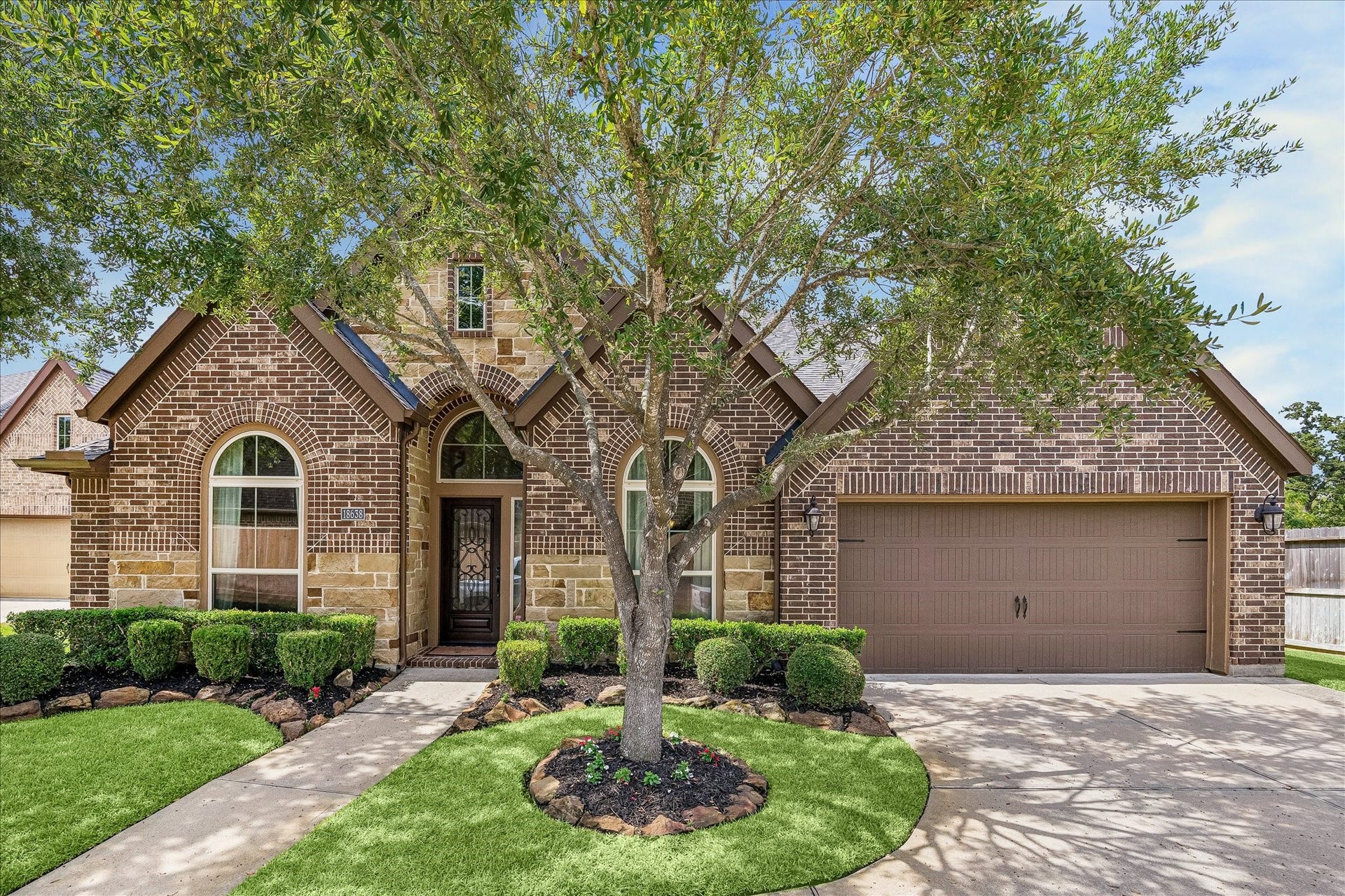 18638 Roslyn Springs Drive, Spring, TX 77388 Mature trees and manicured landscaping frame the home's beautiful exterior.