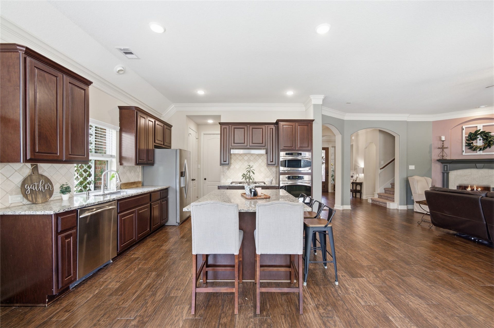 30511 Sethora Hill Way, Fulshear, TX 77441 This kitchen invites you to pull up a seat, stay a little longer, and make memories of your own.