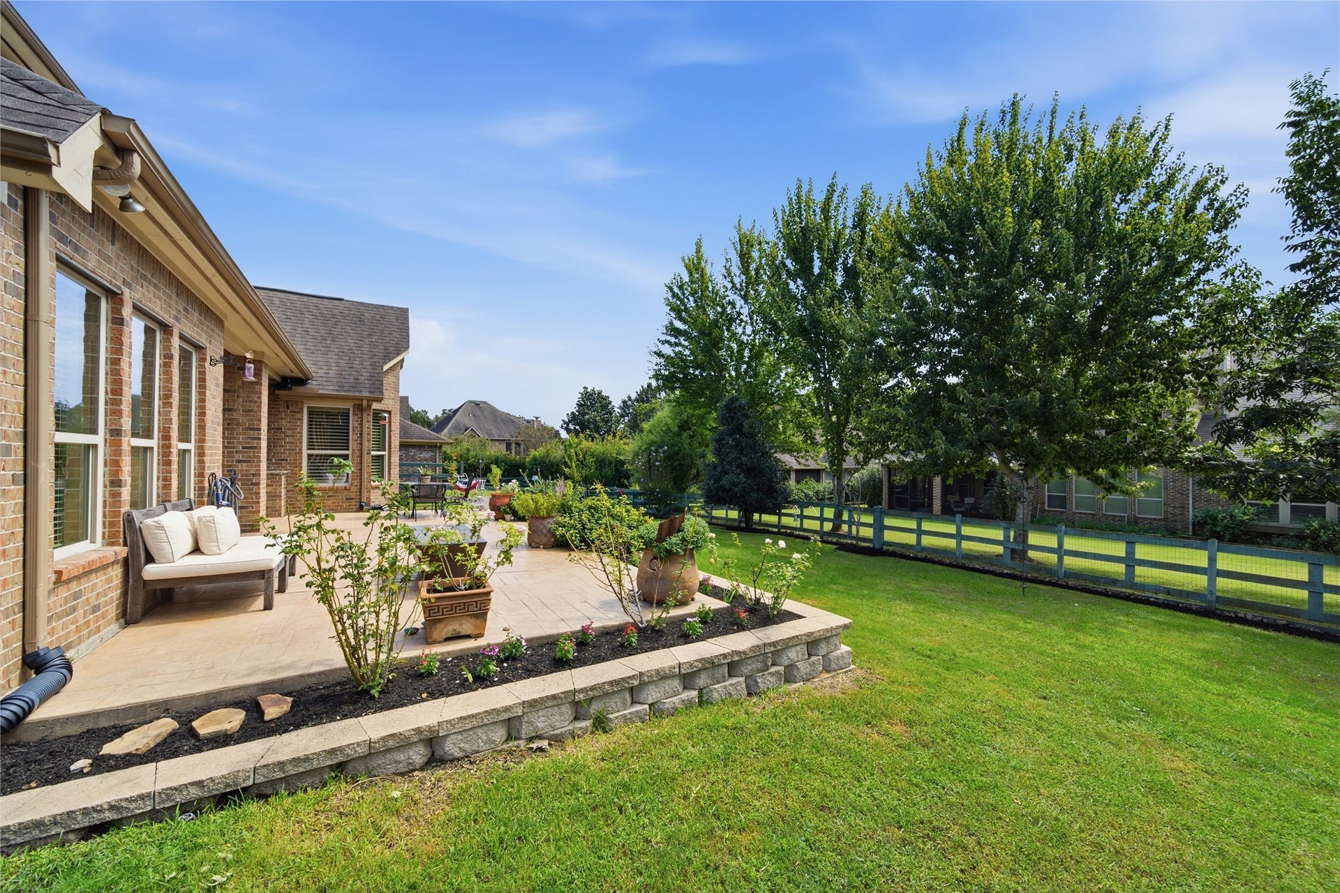 30511 Sethora Hill Way, Fulshear, TX 77441 Mature landscaping and colorful flowers provide a beautiful backdrop, making this outdoor space just as welcoming as the home itself.