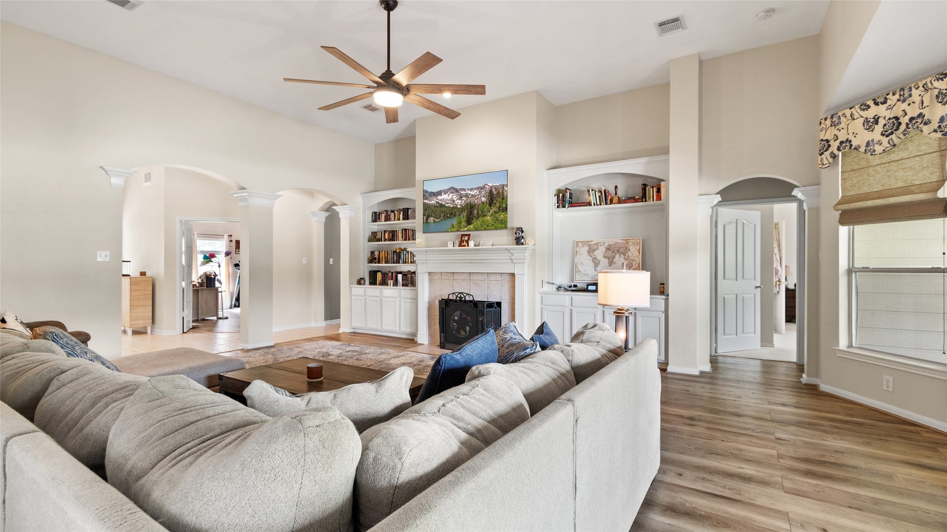 111 County Road 932, Alvin, TX 77511 The wood burning fireplace creates a cozy focal point, framed by built in bookshelves on both sides for extra character and storage.