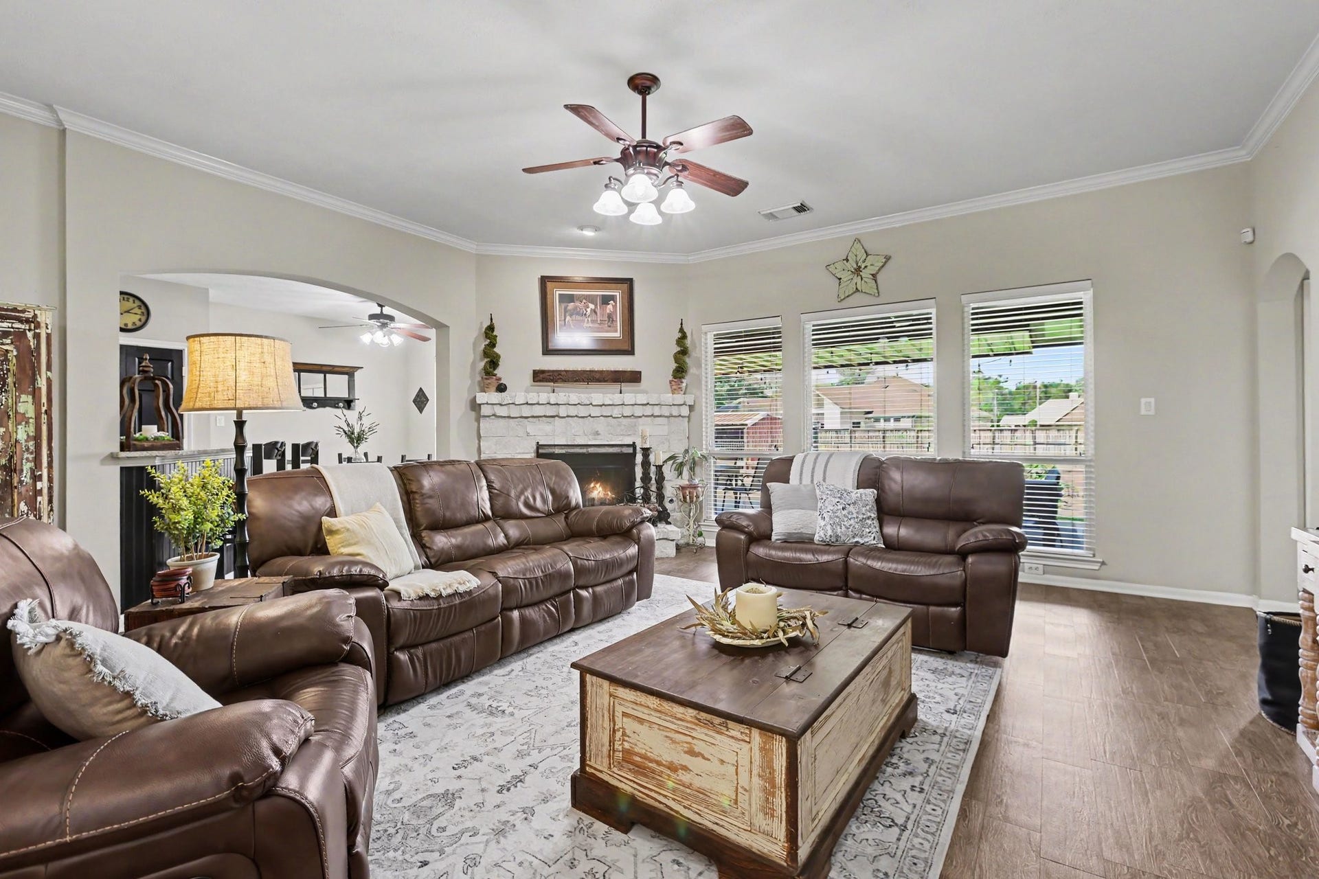 3014 Bowser Road, Fulshear, TX 77441 Living Room with cozy fireplace and wood-look tile flooring