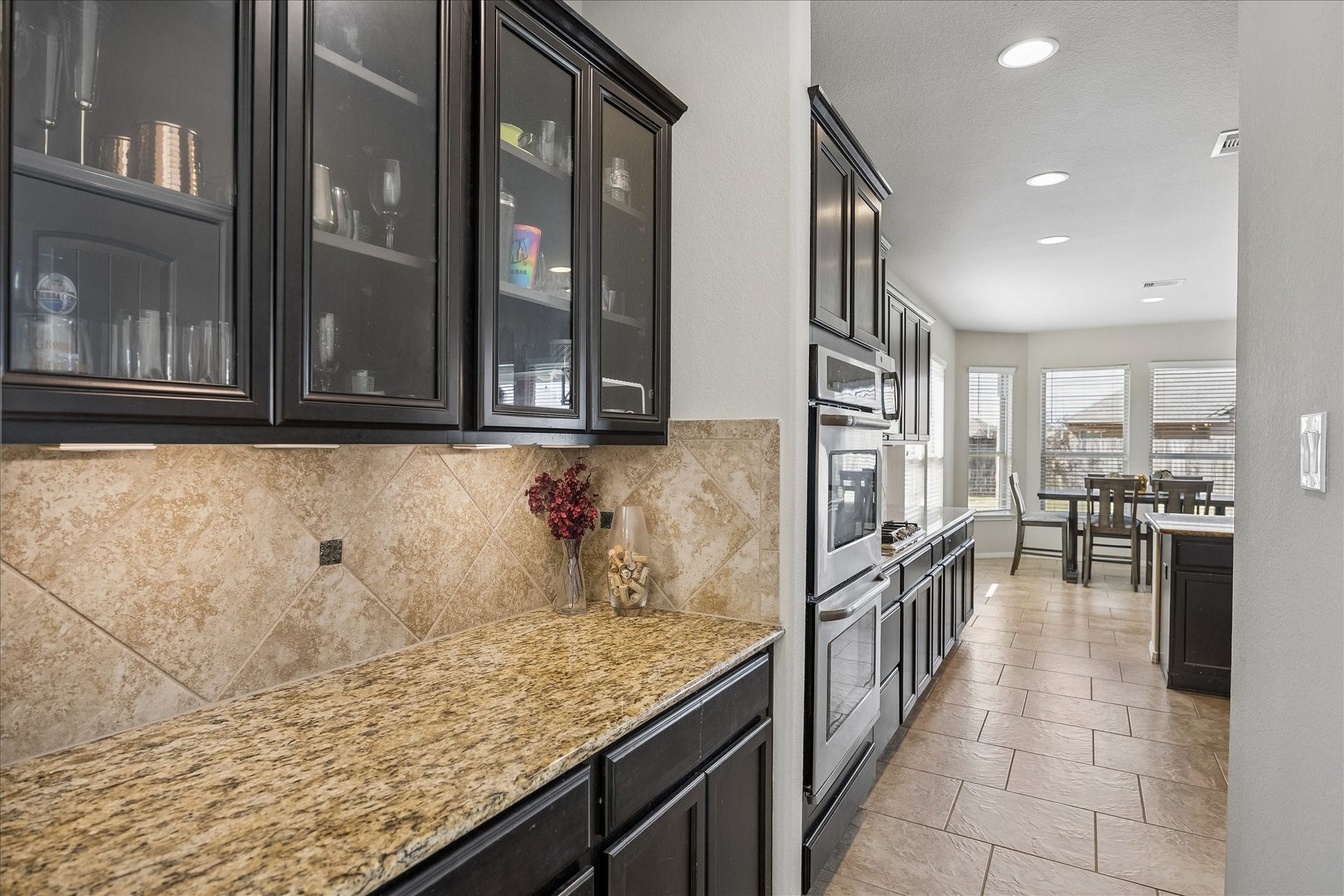 10018 Mahaffey Road, Tomball, TX 77375 Butler's pantry that flows into the kitchen. Perfect for a coffee bar with cabinets for extra storage.