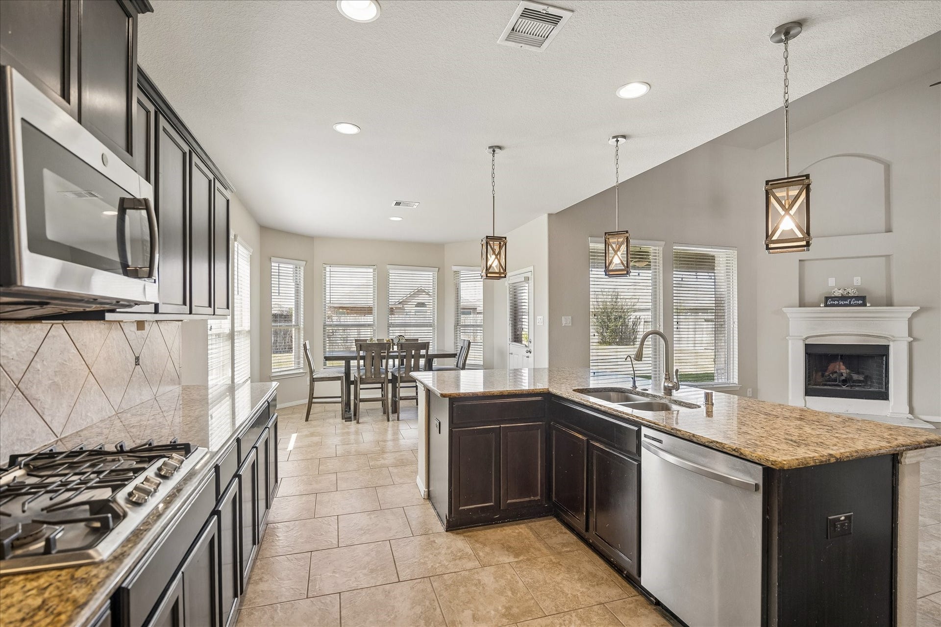 10018 Mahaffey Road, Tomball, TX 77375 Open concept kitchen with stainless appliances and gas range.