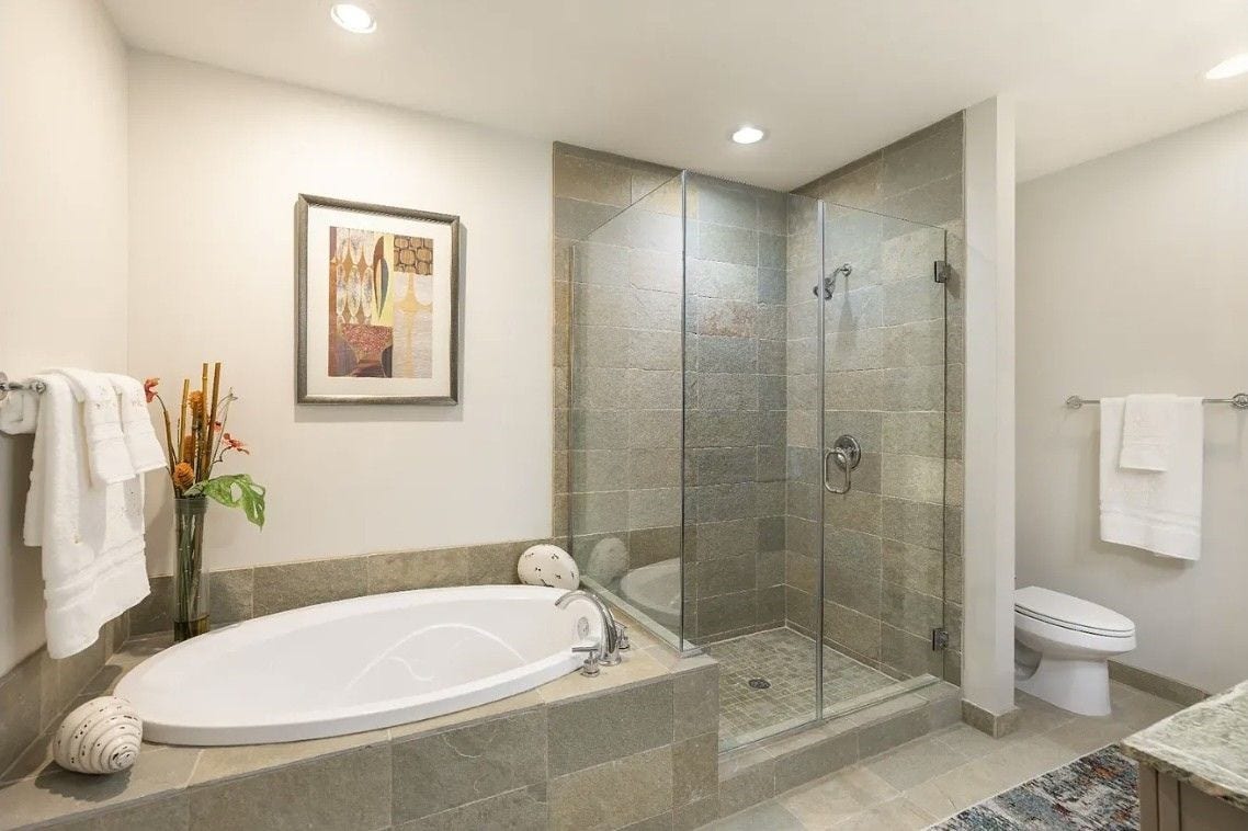 1400 McKinney Street, #2304, Houston, TX 77010 Indulge in a spa-inspired experience with a luxurious soaking tub, separate frameless glass walk-in shower and timeless tile surround. This beautifully appointed bathroom offers the perfect space to relax and recharge after a long day.