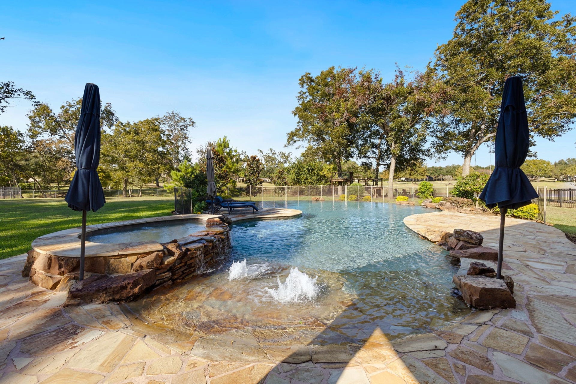 22 Parsonage Cove, Missouri City, TX 77459 Zero entry, large hot tub, waterfall, and infinity edge pool really offer a retreat feel!