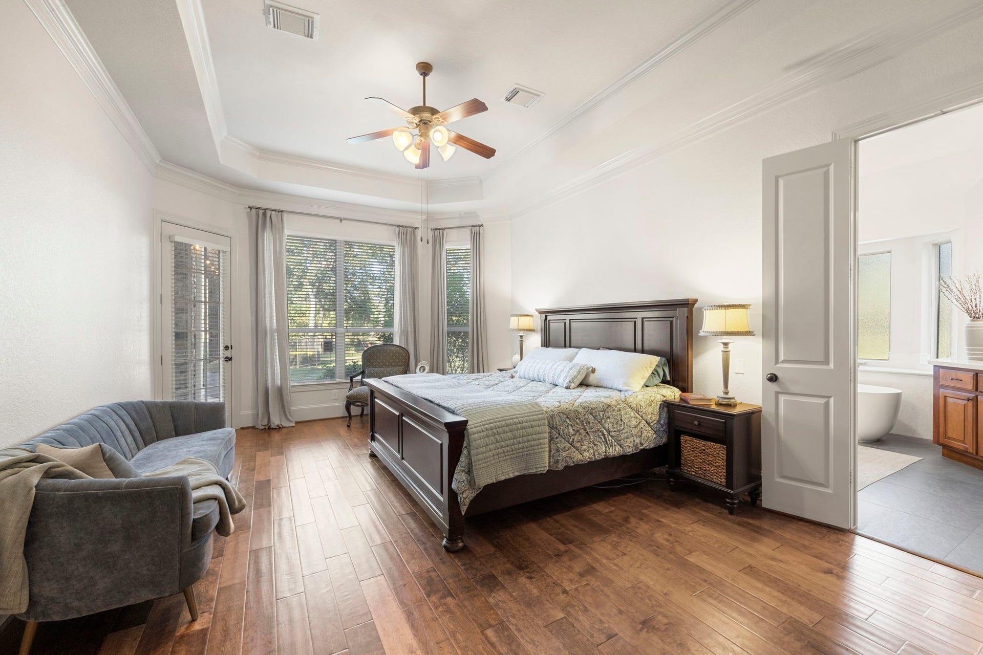 22 Parsonage Cove, Missouri City, TX 77459 A true Primary Retreat awaits you featuring tall tray ceilings, fresh designer paint, rich wood floors, tons of natural light coming in from the Bay Window sitting area.