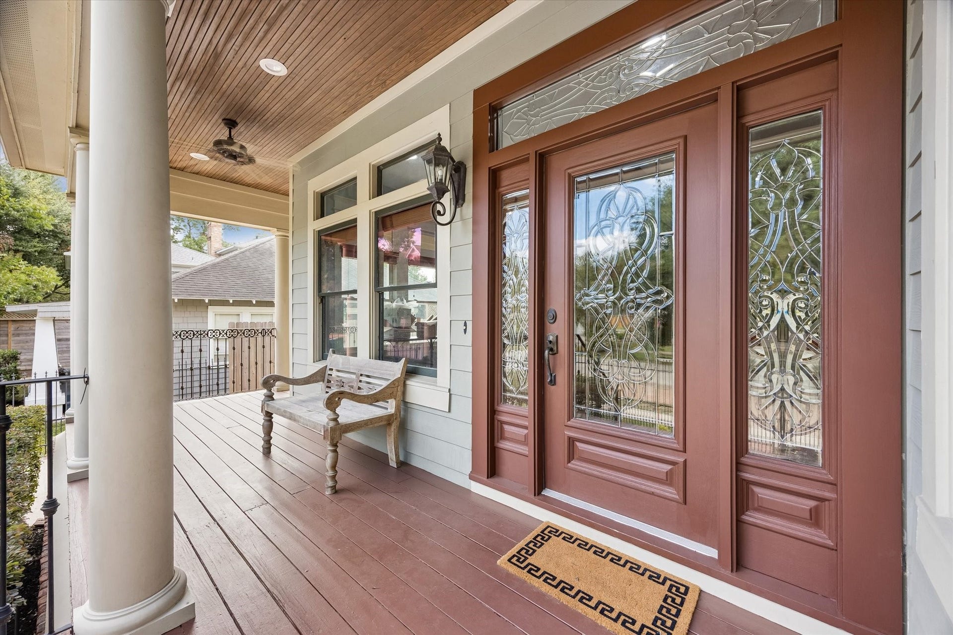 Come sit for a bit! This wide covered wraparound porch pairs classic Heights charm with a showstopping leaded glass entry, warm wood ceiling, handsome coach lighting and plenty of room to relax and take it all in before you ever step inside.