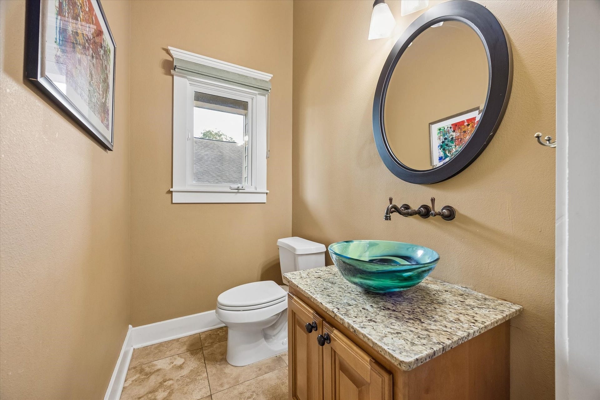 Even the powder bath has a lot of personality. A striking vessel sink, wall mounted fixtures, custom mirror and stylish lighting give this first floor bath a polished, custom feel.