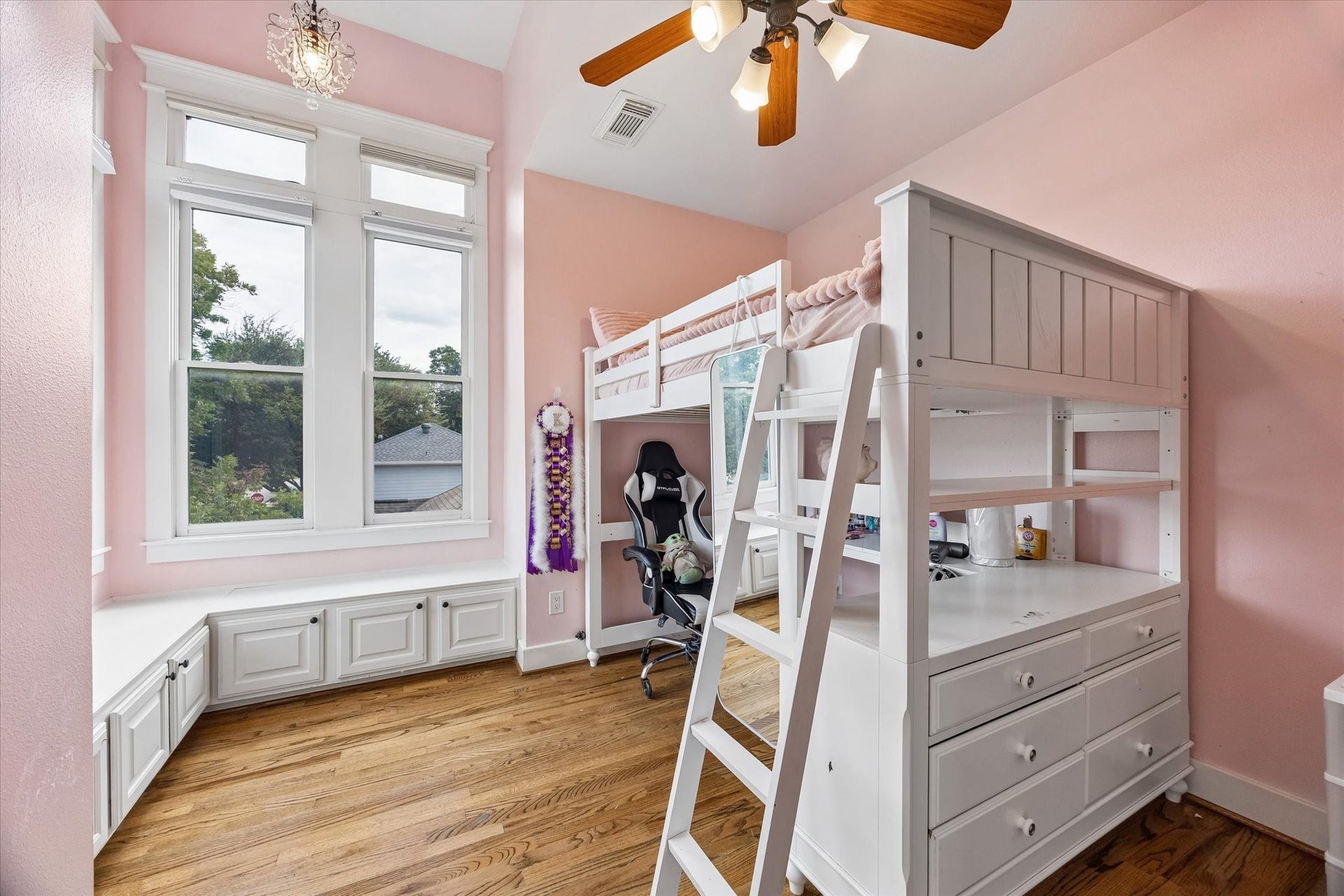 This bedroom brings the charm in a big way, with tall windows, warm wood floors and built-in window seats that practically beg for a stack of books and a lazy afternoon. Add hidden storage, a walk-in closet and easy access to a full bath, and this sweet room has plenty of function tucked into all that personality.