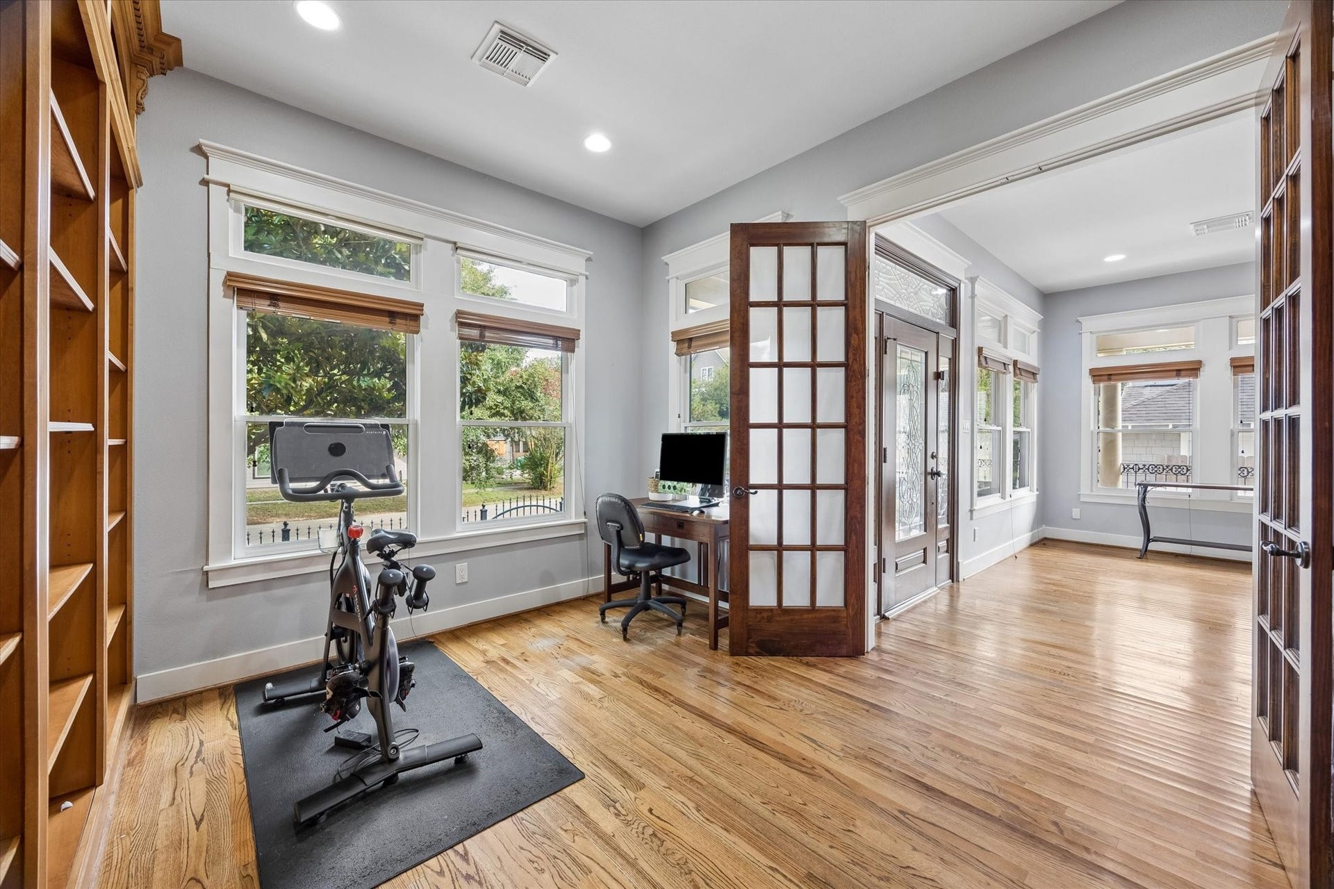 This is the kind of space that makes it a little easier to settle in and stay productive. Use it as an at home office, reading retreat or cozy library, with warm wood floors, tall windows and impressive floor to ceiling shelving that set just the right mood to get stuff done.