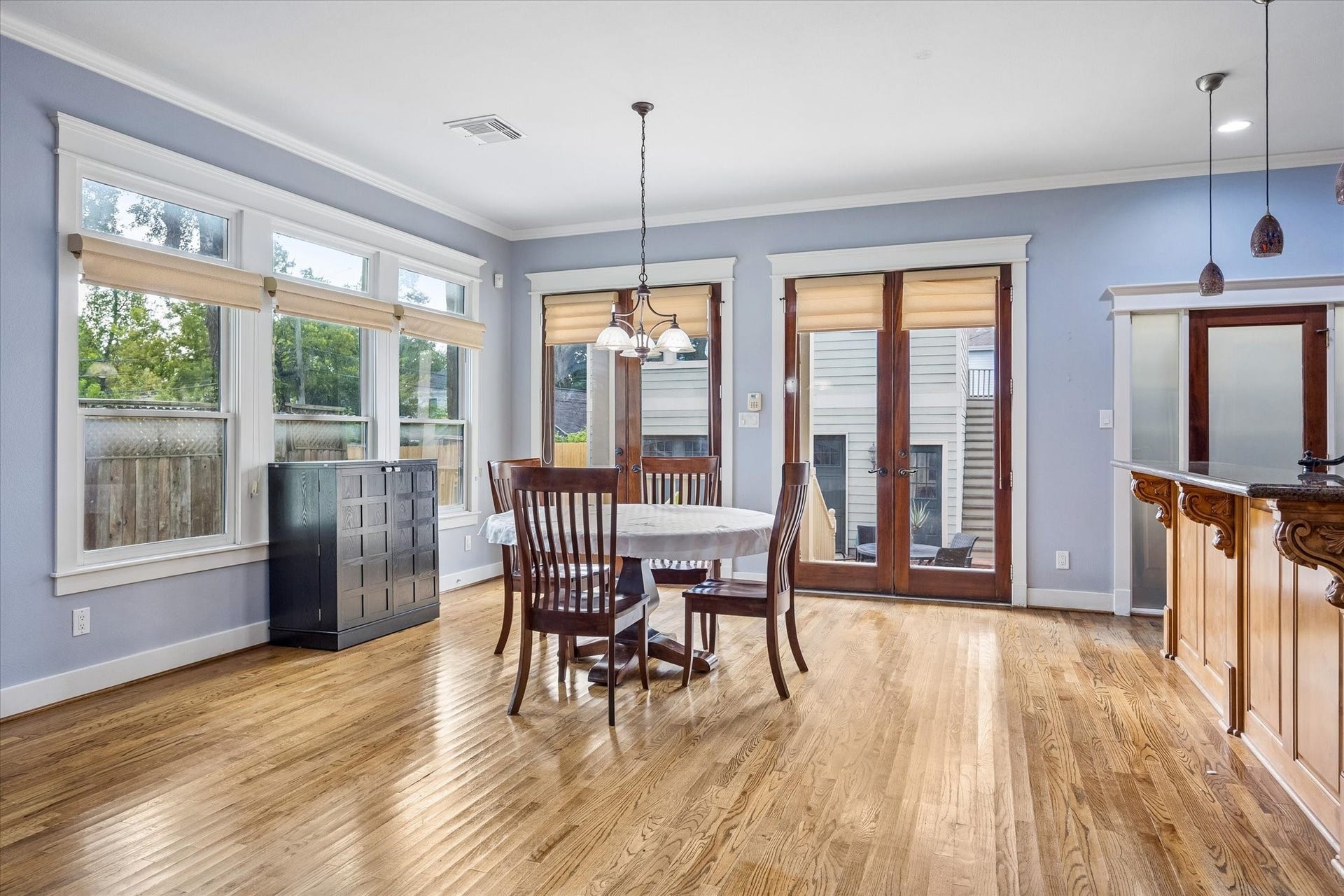 Breakfast with a view makes mornings a little sweeter. Tall windows and beautiful French doors fill the casual dining area with natural light, creating an easy spot for coffee, quick meals, late night snacks and everything in between.