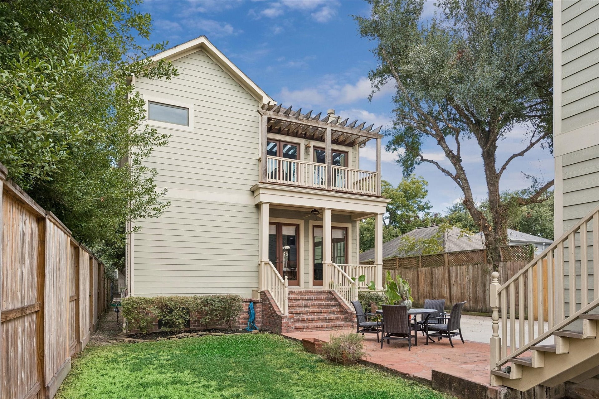 Take another look at your new backyard. Enjoy the expansive patio, covered porch, upper gallery, grassy lawn, and private gated driveway.