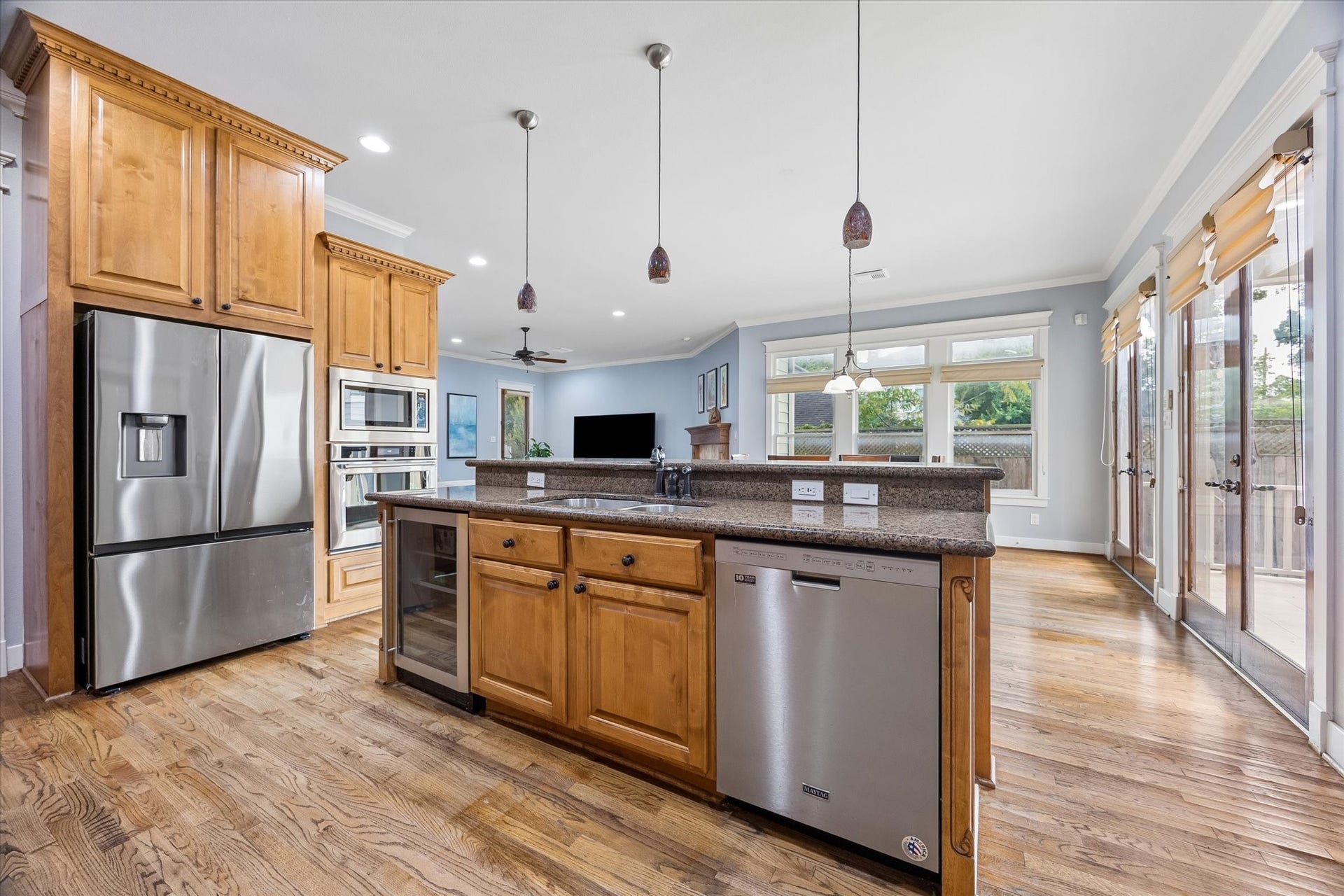 Show off your culinary skills in this chefs kitchen, where custom wood cabinetry, granite countertops, stainless steel appliances and two pantries bring serious function to the space. Easy open access to the living and dining areas keeps the cook connected to the conversation and makes entertaining feel natural.