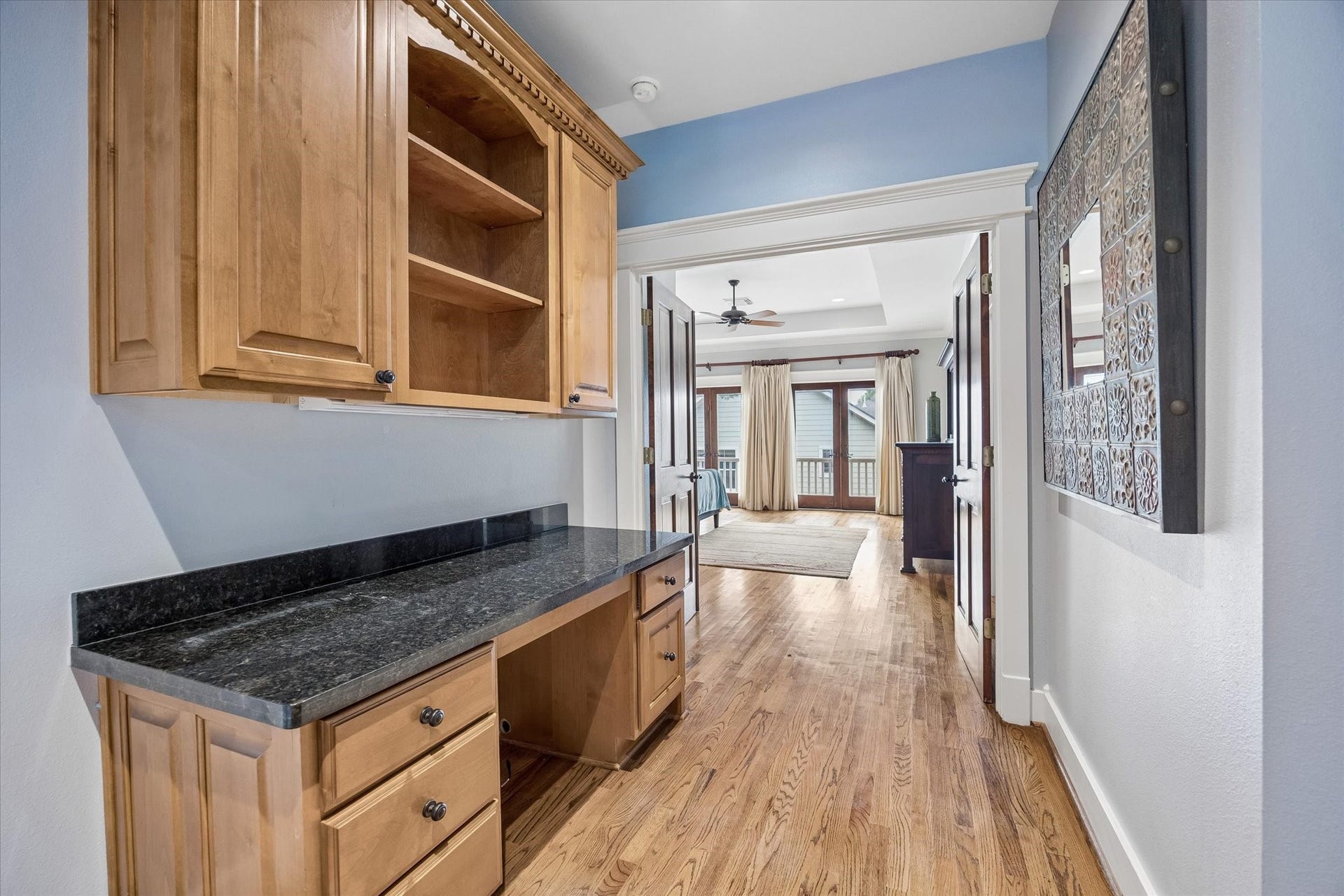Before you reach the primary bedroom, this custom nook adds a thoughtful, functional touch of its own. Built-in cabinetry, a granite counter and hardwood floors make it perfect for creative projects, catching up on emails or simply enjoying a quiet space to yourself.