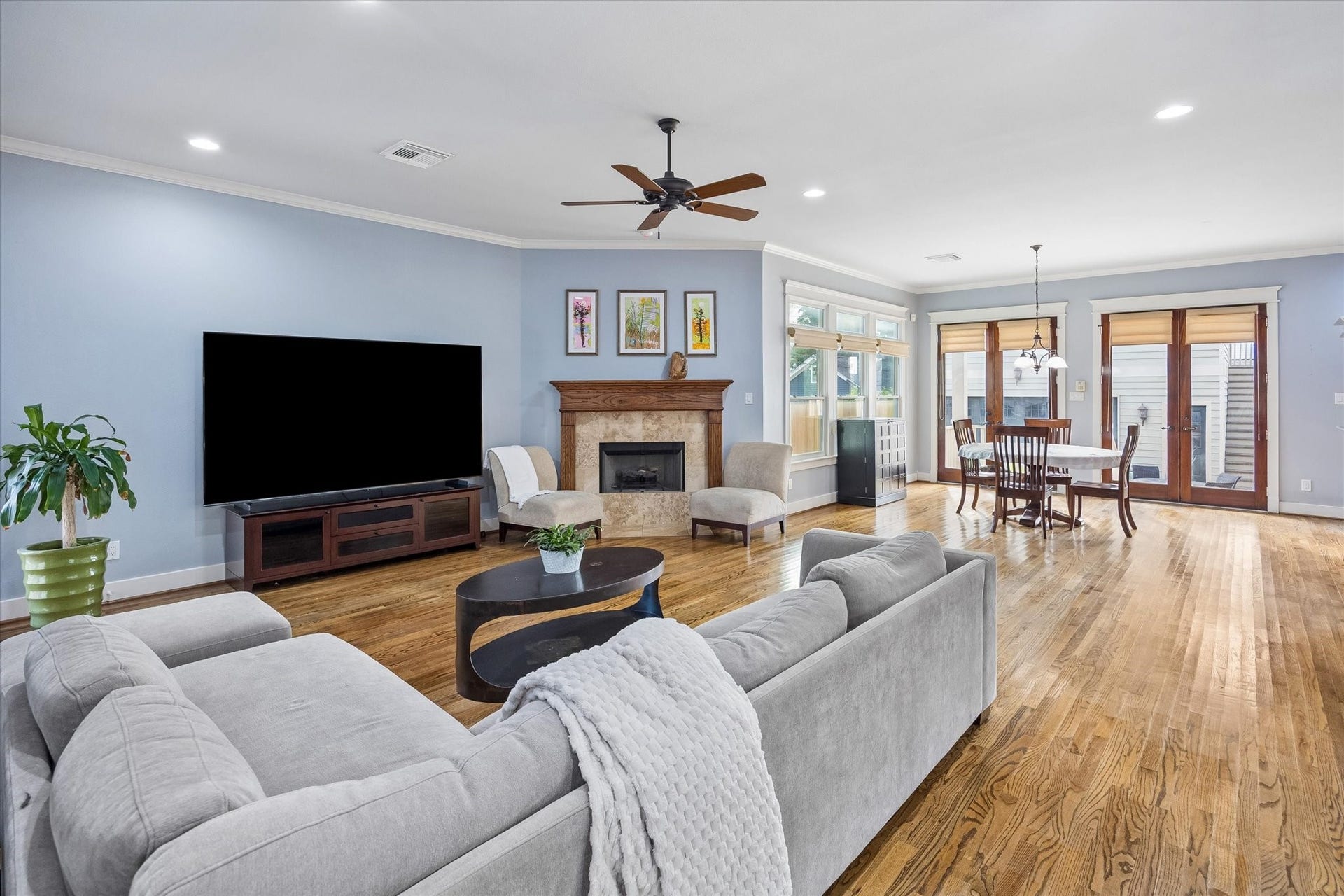 Cozy in all the right ways yet spacious enough for a crowd, this family room strikes a beautiful balance. Hardwood floors, crisp millwork, tall windows and a gas log fireplace bring warmth and character, while the open connection to the dining areas and kitchen keeps everything feeling bright, comfortable and easy to love.