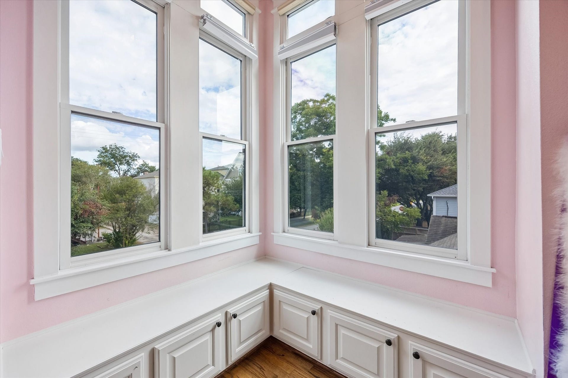 These built-in window seats may just become the favorite little perch. Wrapped in tall windows with neighborhood views and tucked over hidden storage, they give this room a cozy touch of character that feels perfect for reading, relaxing or daydreaming.