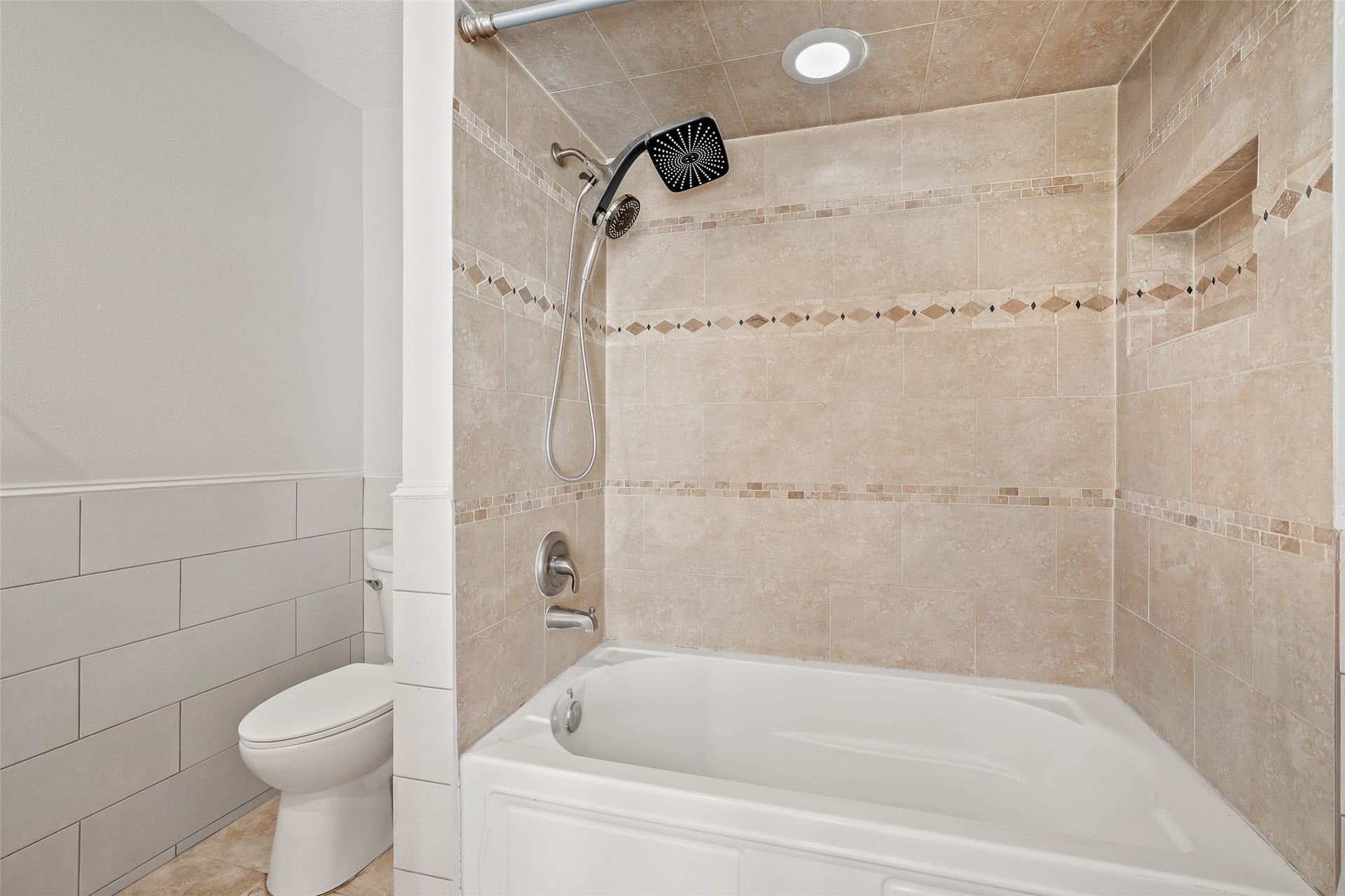 25806 Old Carriage Lane, Spring, TX 77373 Bathroom featuring a tiled shower and bath combo.