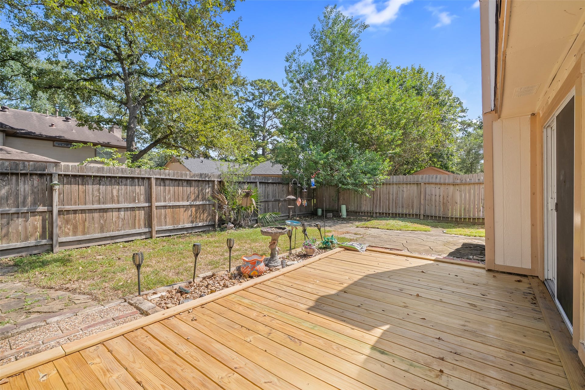 25806 Old Carriage Lane, Spring, TX 77373 Spacious backyard with a wooden patio.
