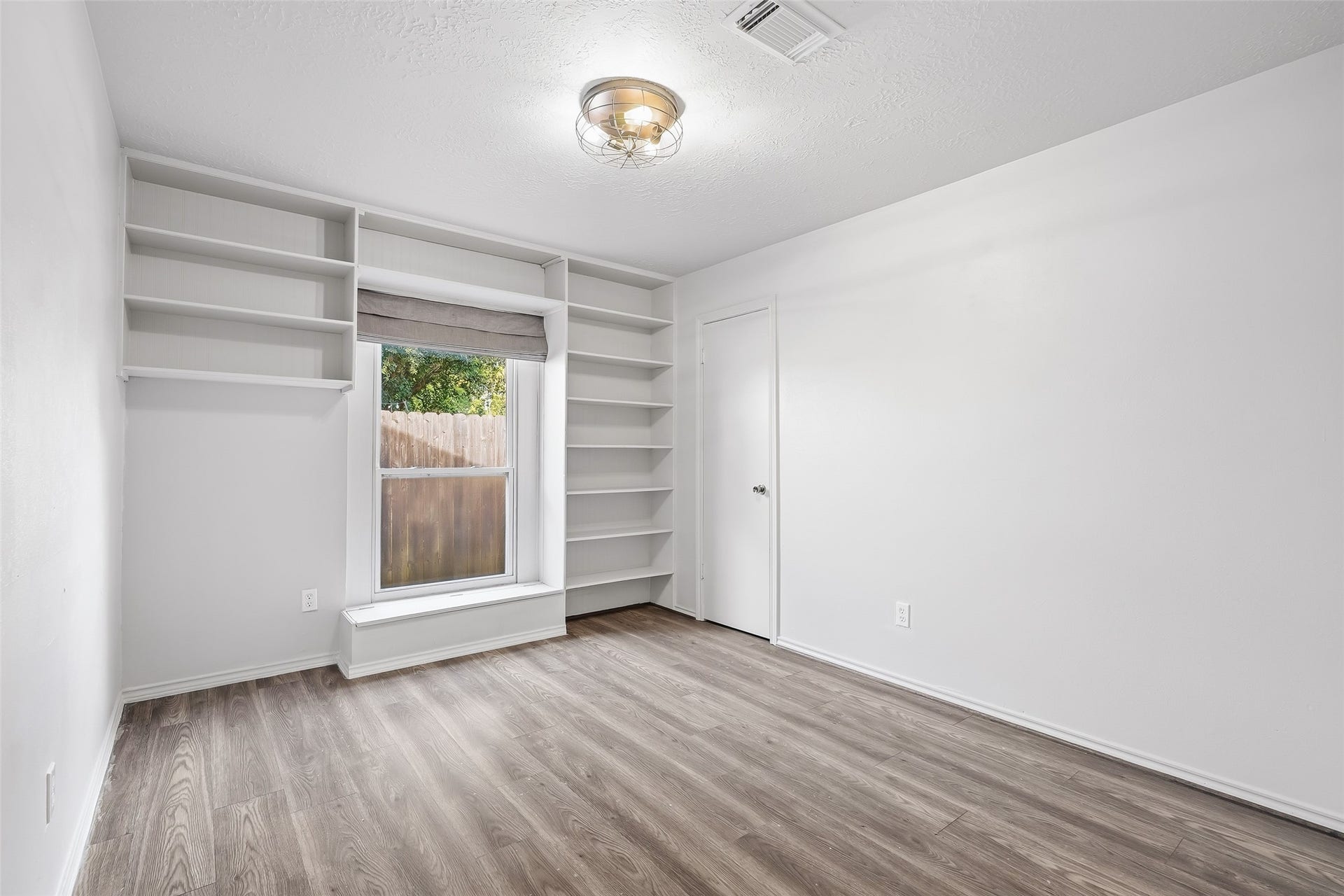 25806 Old Carriage Lane, Spring, TX 77373 Bright and inviting room featuring built-in shelving and a large window.