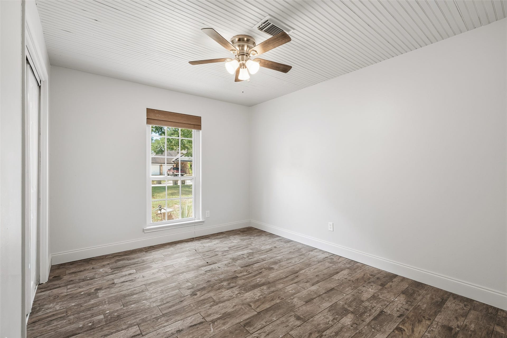 25806 Old Carriage Lane, Spring, TX 77373 Step into this serene bedroom retreat, featuring a large window, ceiling fan and decorative ceiling.