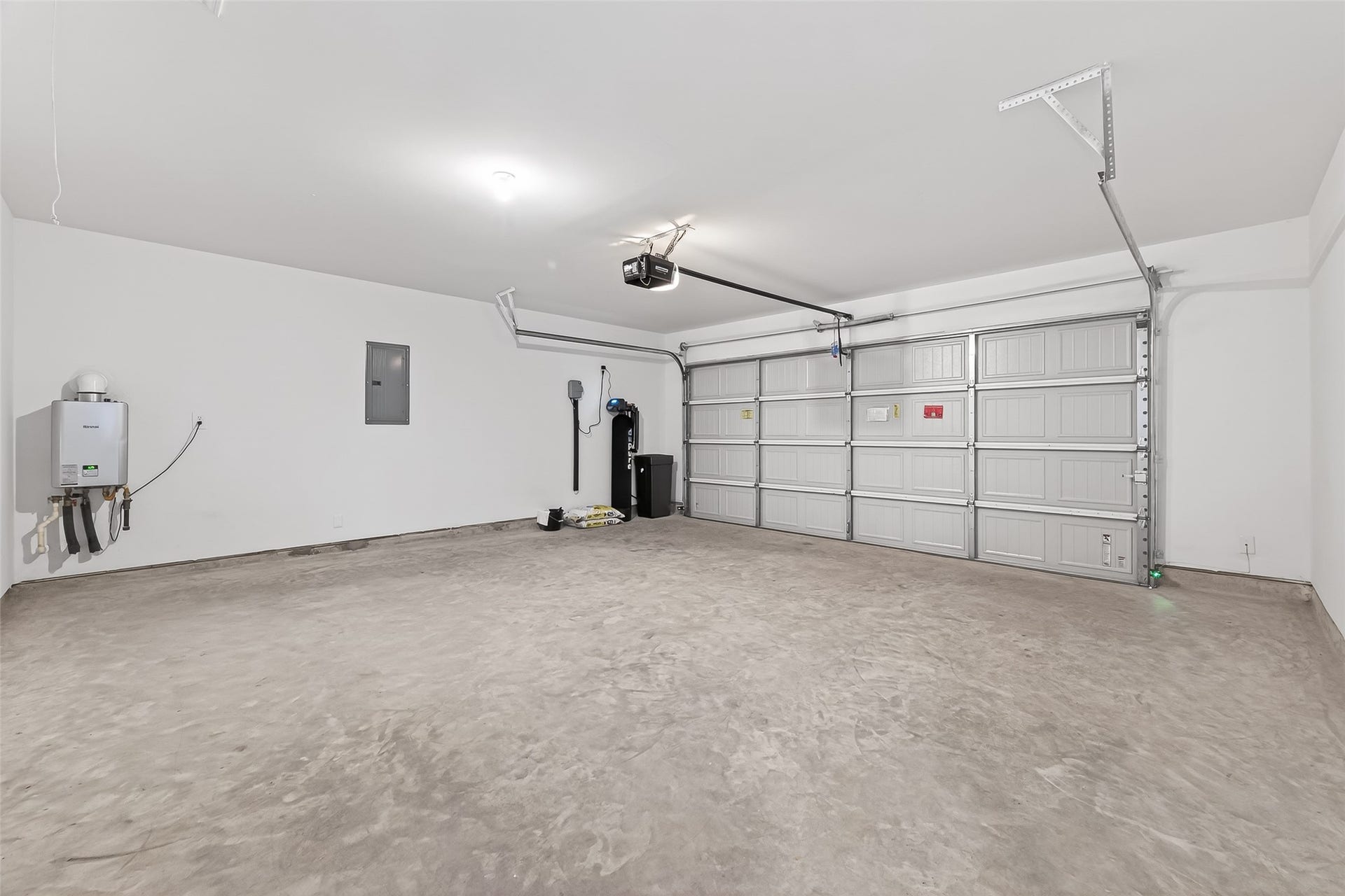 27410 Oceanus Springs Drive, Katy, TX 77493 Garage featuring instant hot water heater, water softener system